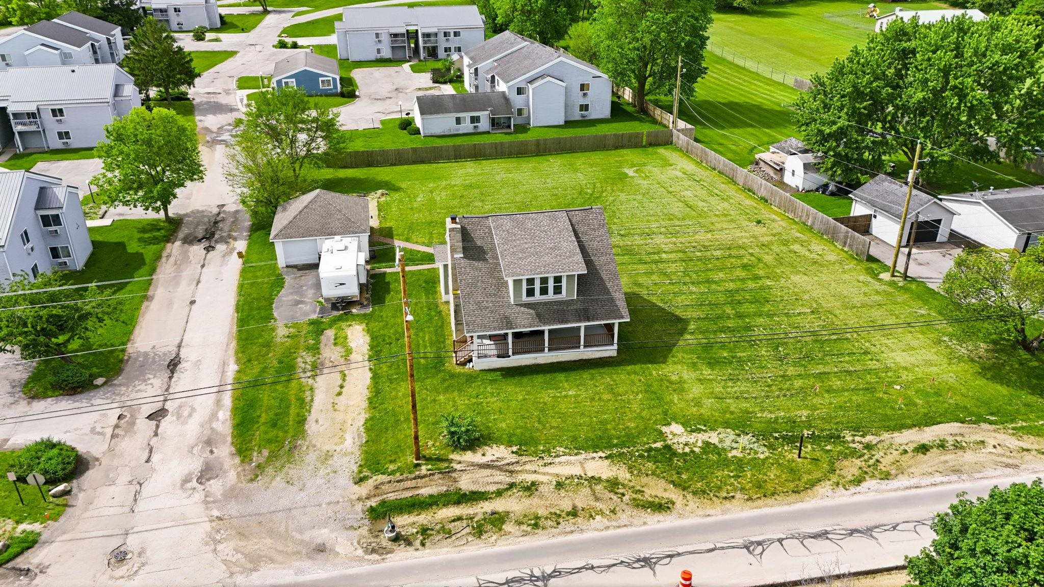 Detached single-family residence featuring a prominent covered porch and multiple dormer windows