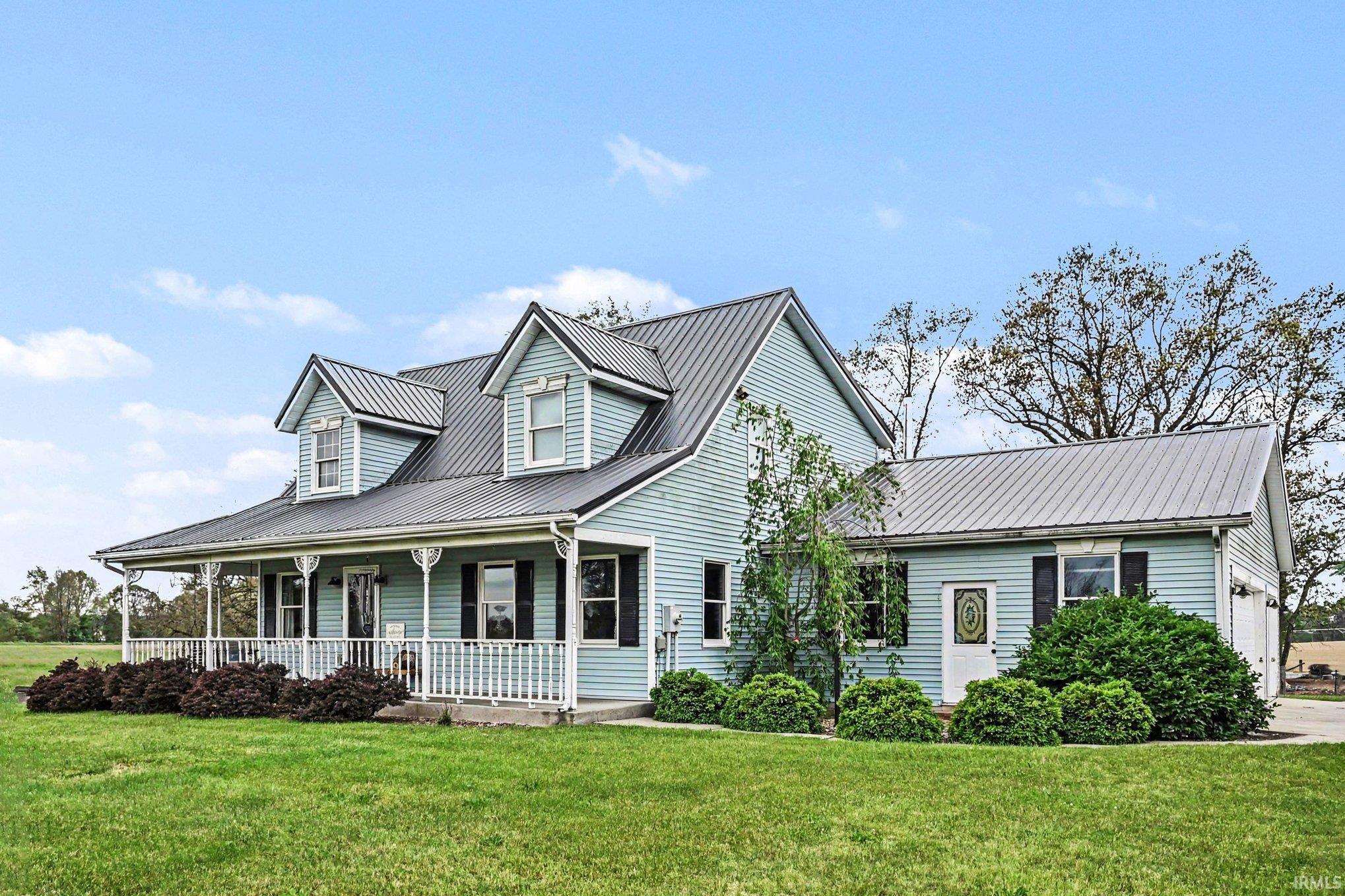 Light blue siding exterior with a metal roof