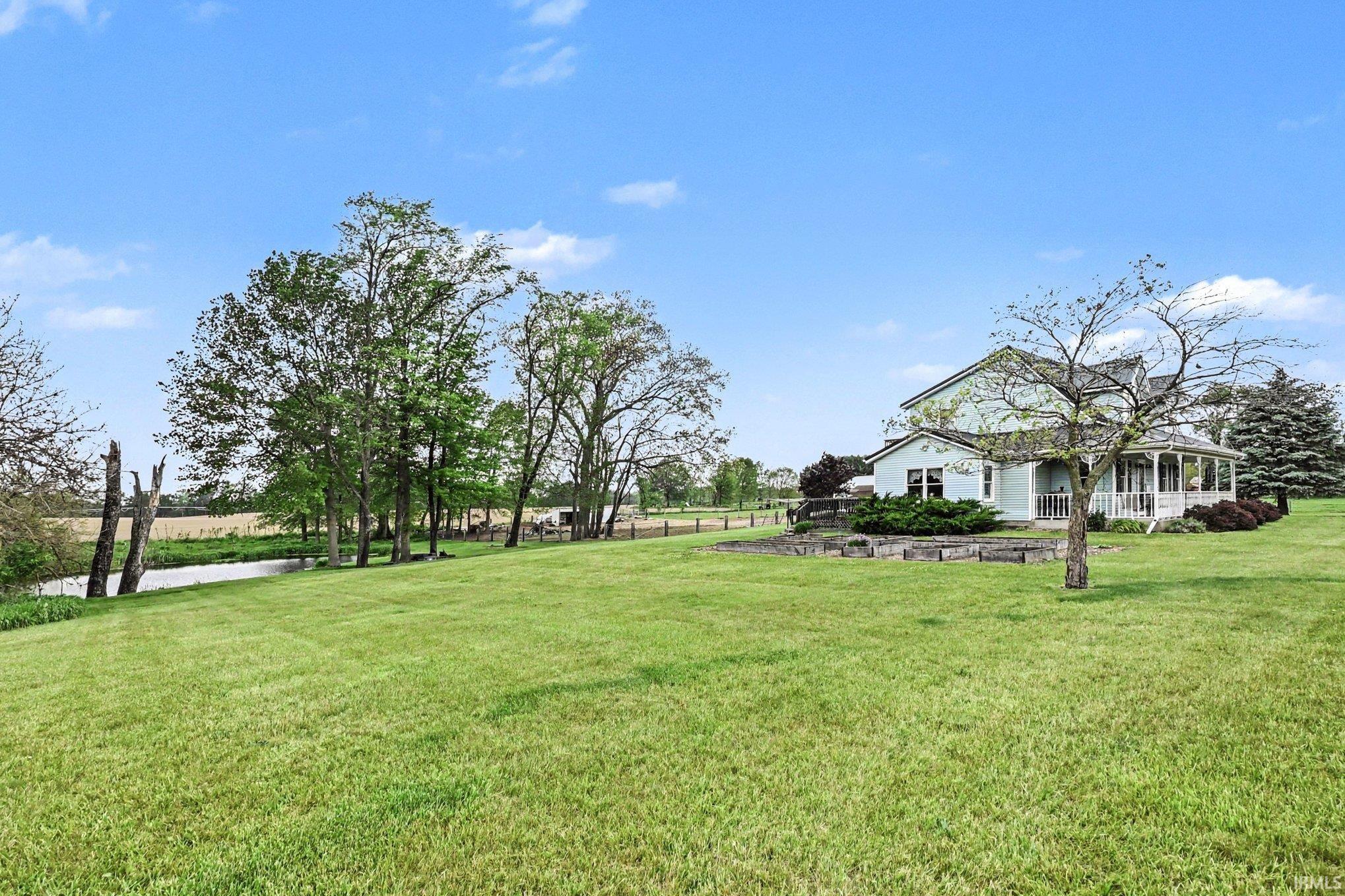 Expansive green lawn bordering a natural water feature