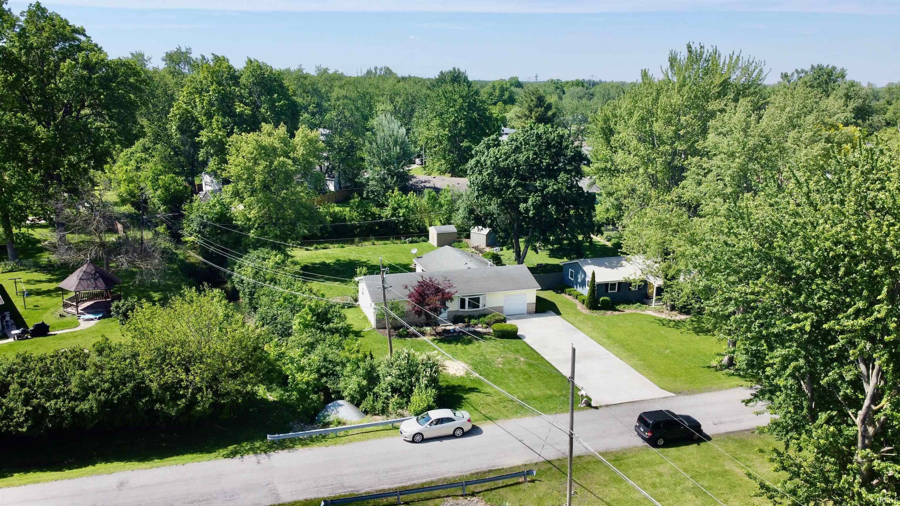 Single-story residence featuring a two-car garage, concrete driveway, and manicured front lawn