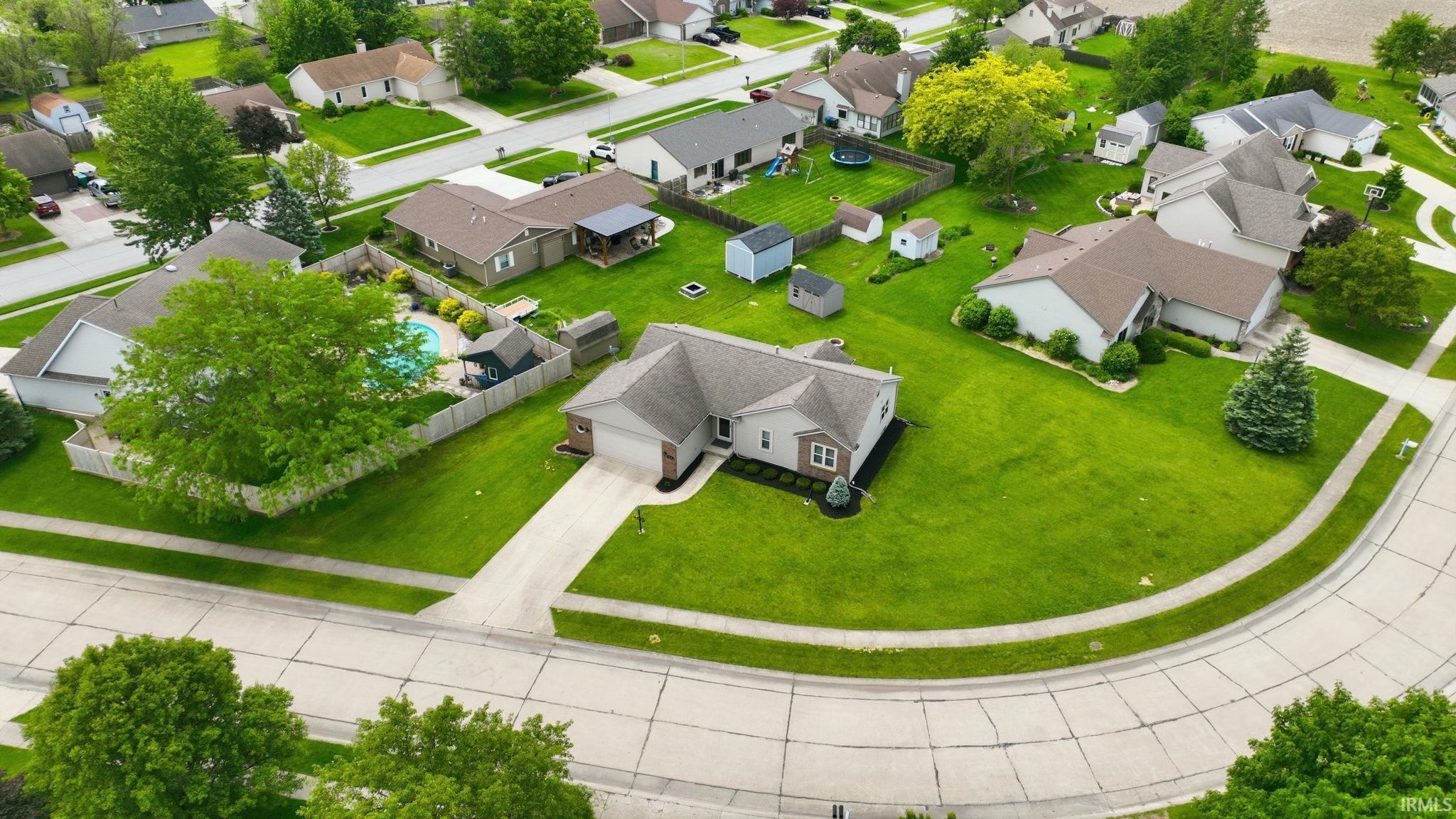 Single-story residence on a cul-de-sac lot, featuring an attached garage and a private backyard with an in-ground swimming pool