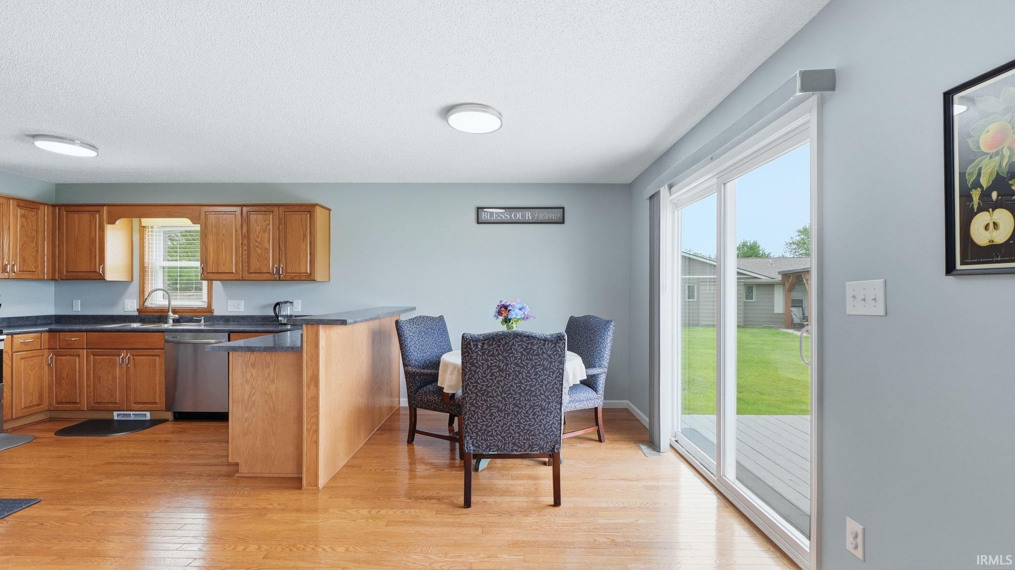 Open-concept kitchen and dining area with wood-finish flooring