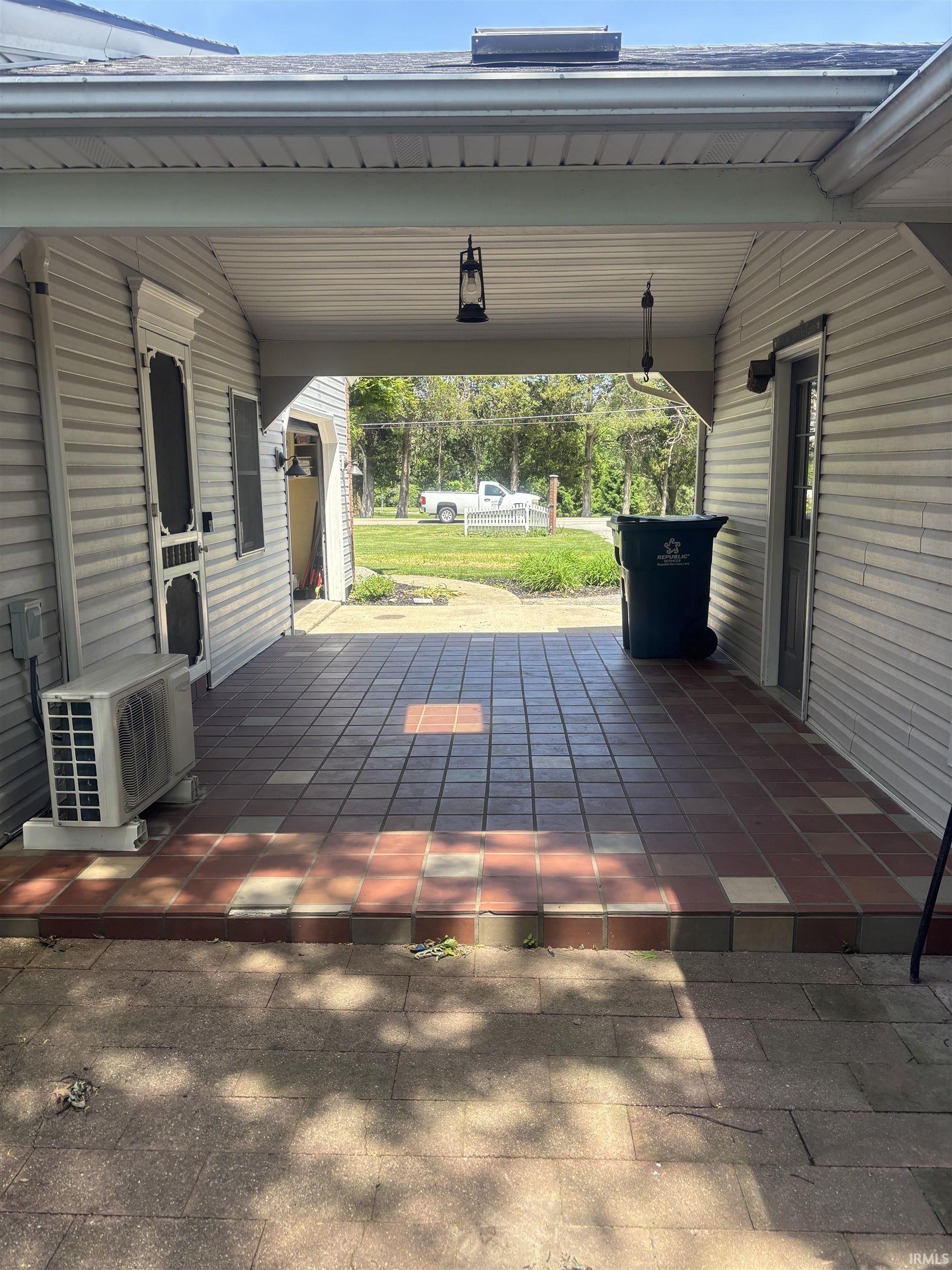 Covered outdoor area featuring a tiled floor and siding exterior