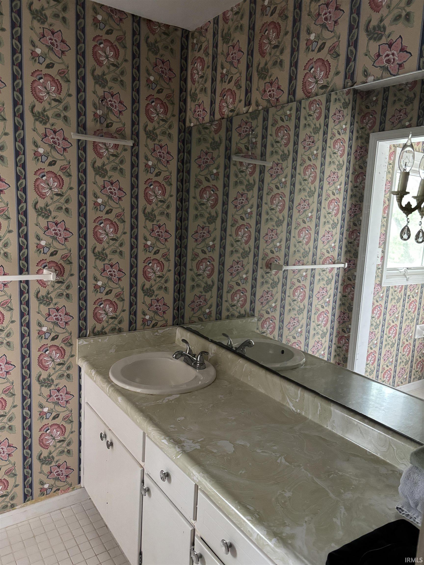 Bathroom vanity featuring an integrated sink, dual-handle faucet, and an expansive countertop