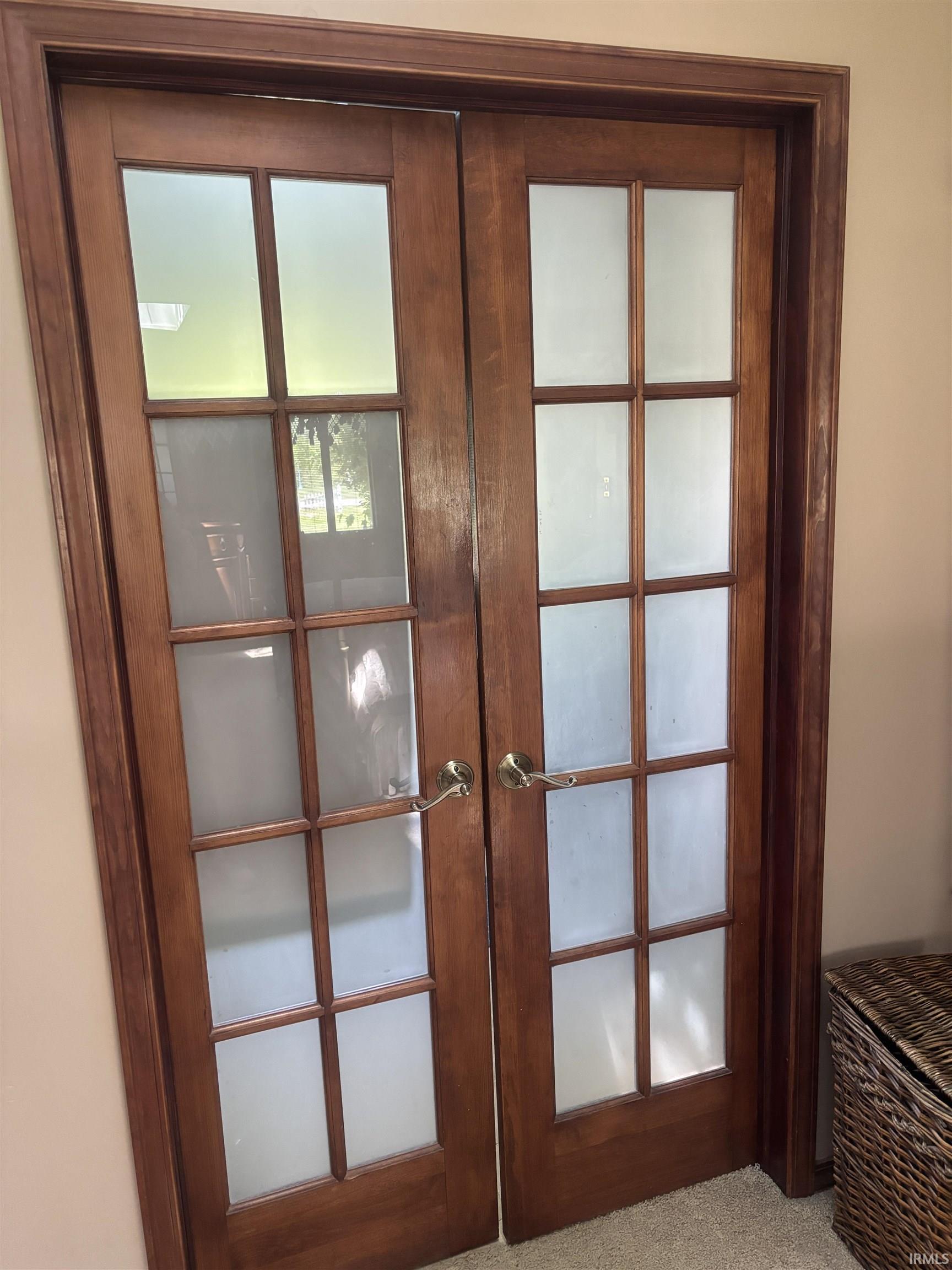Double French doors with wood-finish frames and frosted glass panels