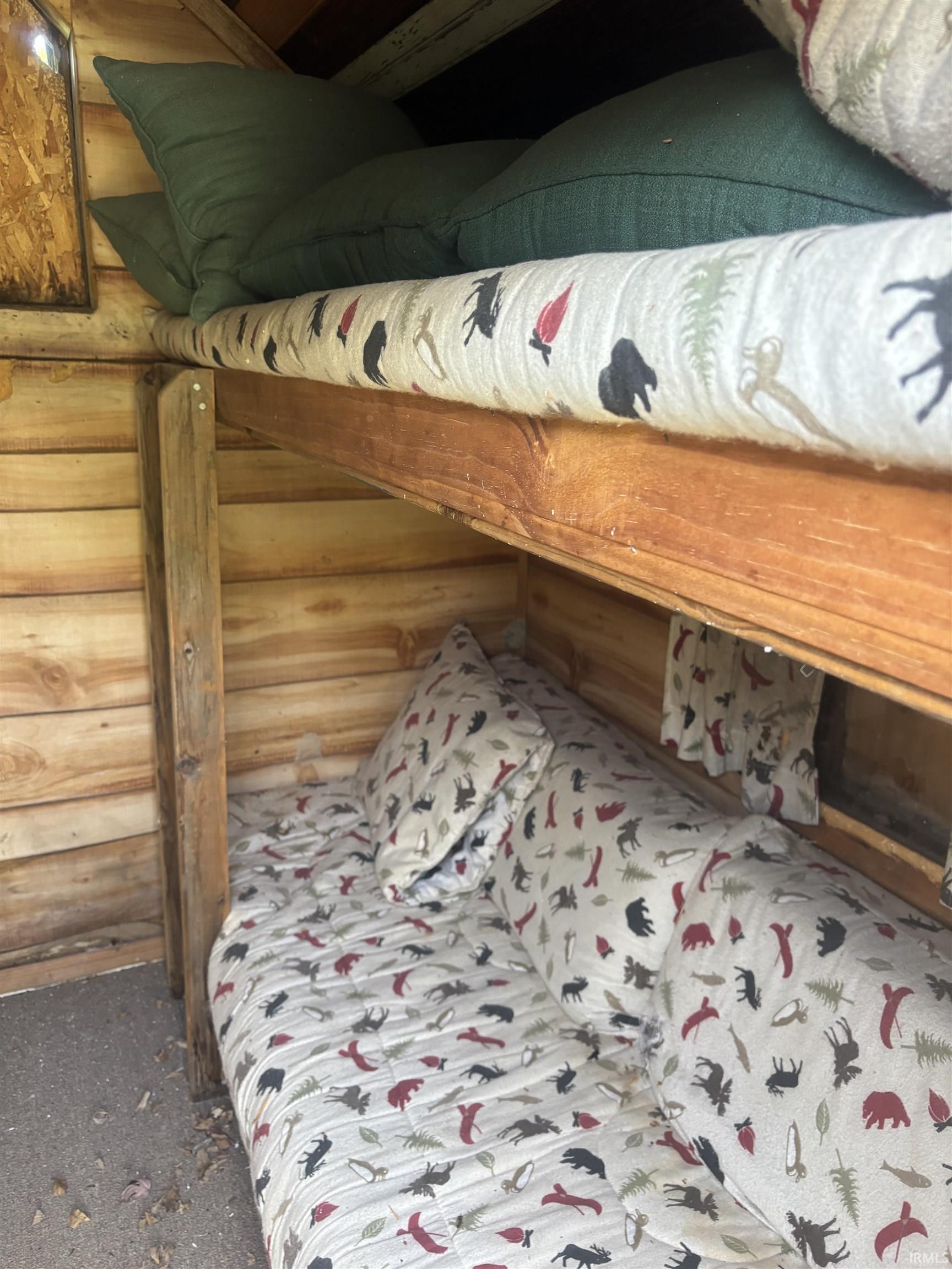 Built-in bunk bed structure featuring natural wood construction and a horizontal wood plank wall