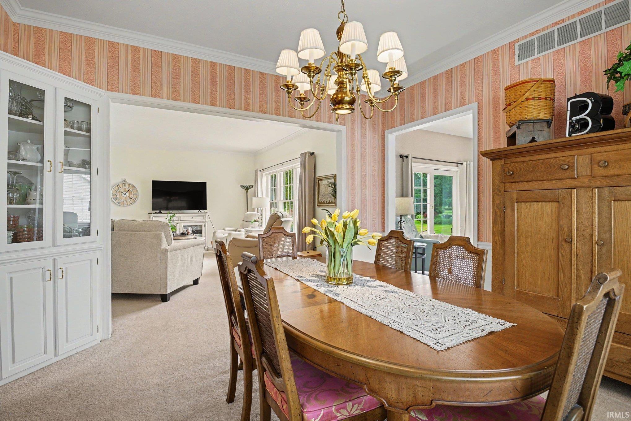 Formal dining area off from kitchen and opening to both the living room and den
