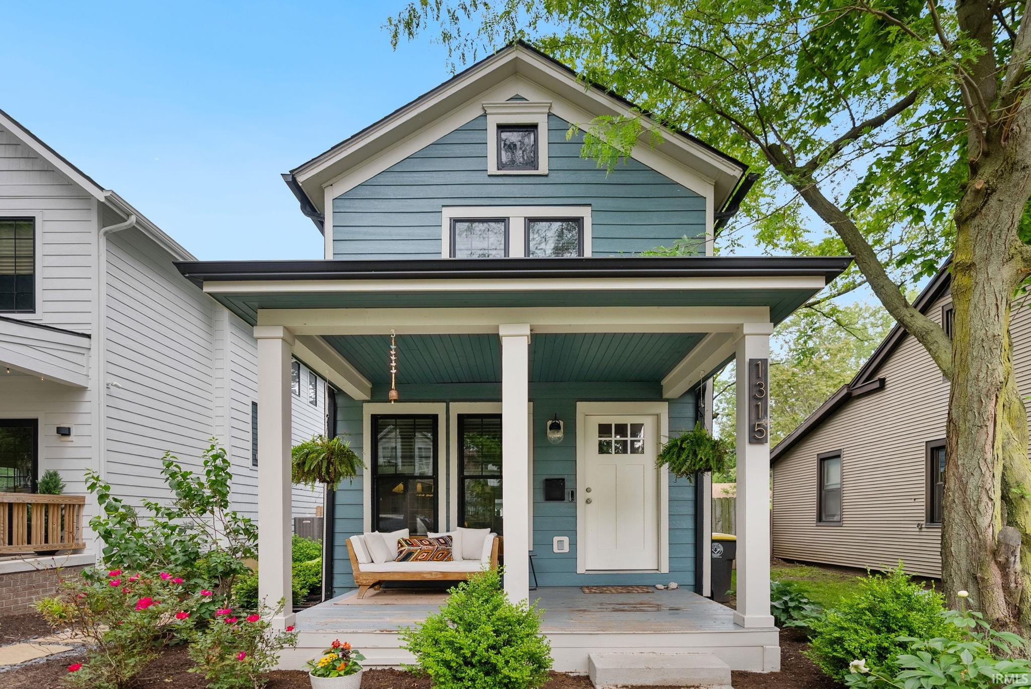 Contemporary Craftsman-style exterior featuring deep blue siding and white trim