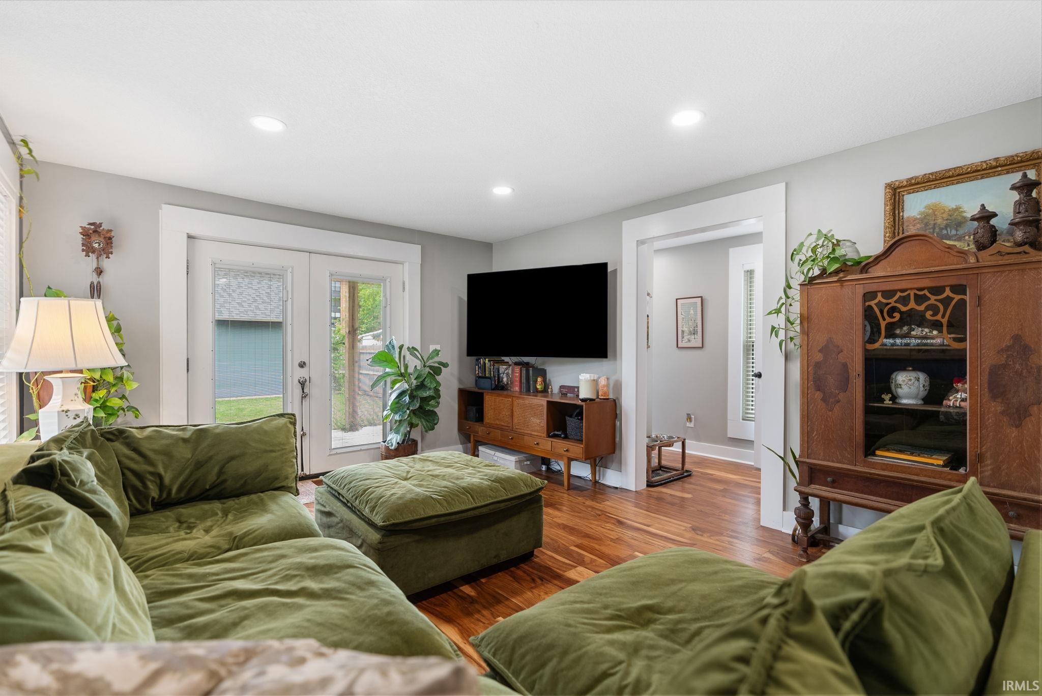 Living area featuring wood-finish flooring, recessed lighting, and a neutral wall color