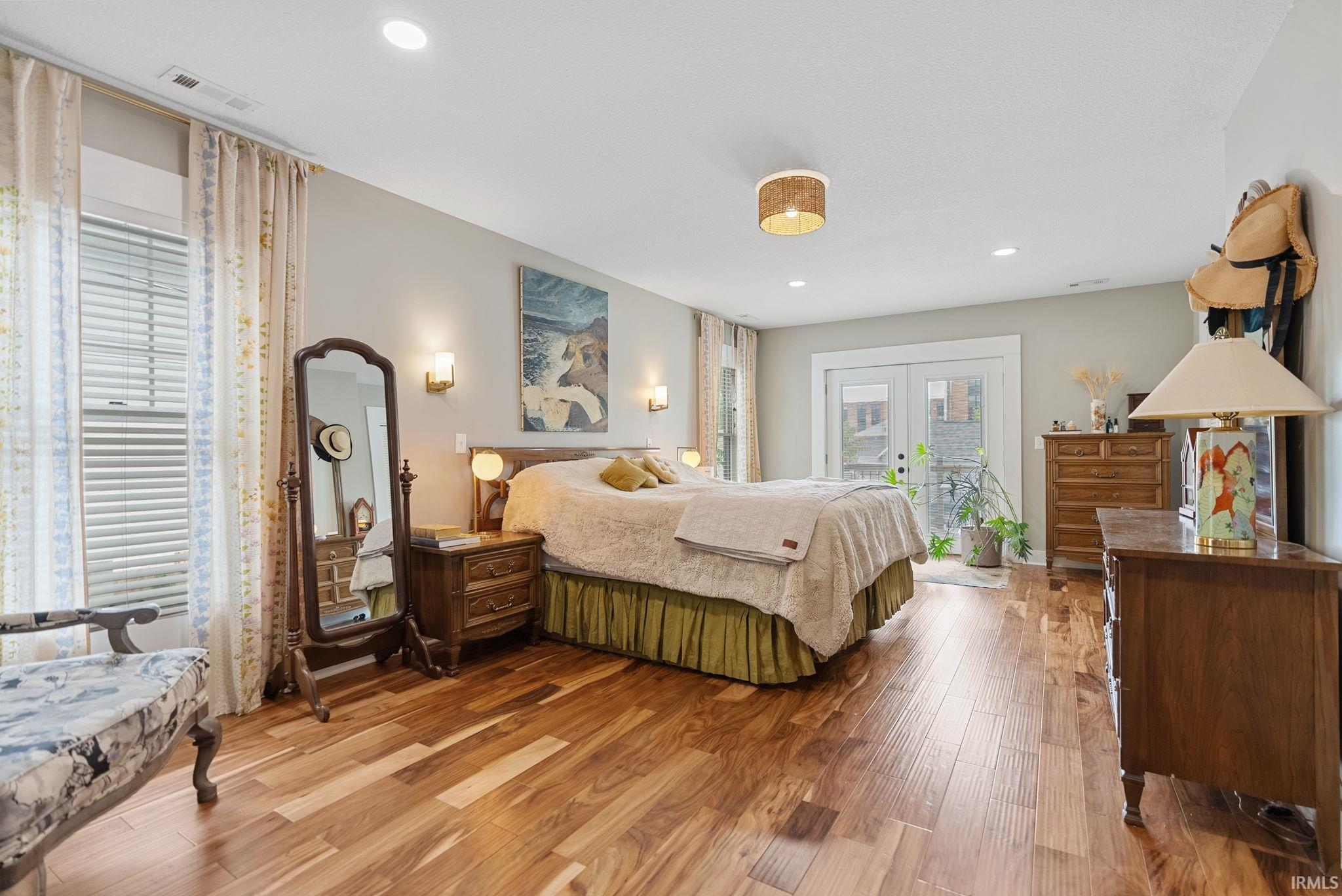Spacious room featuring wood-finish flooring, recessed lighting, and a neutral wall color
