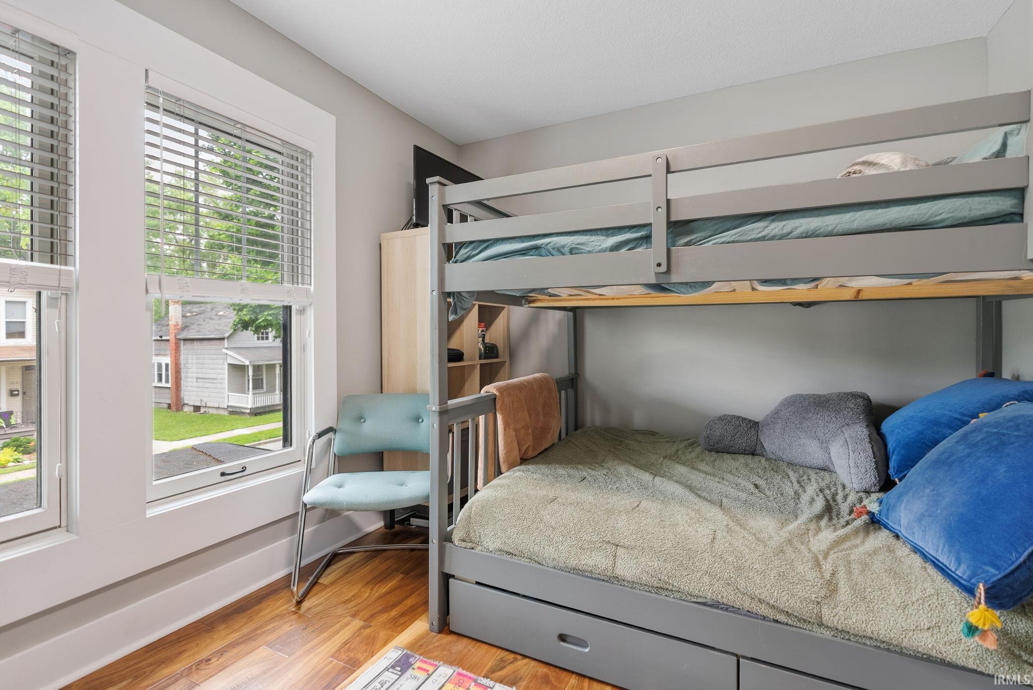Wood-finish flooring paired with white window casings
