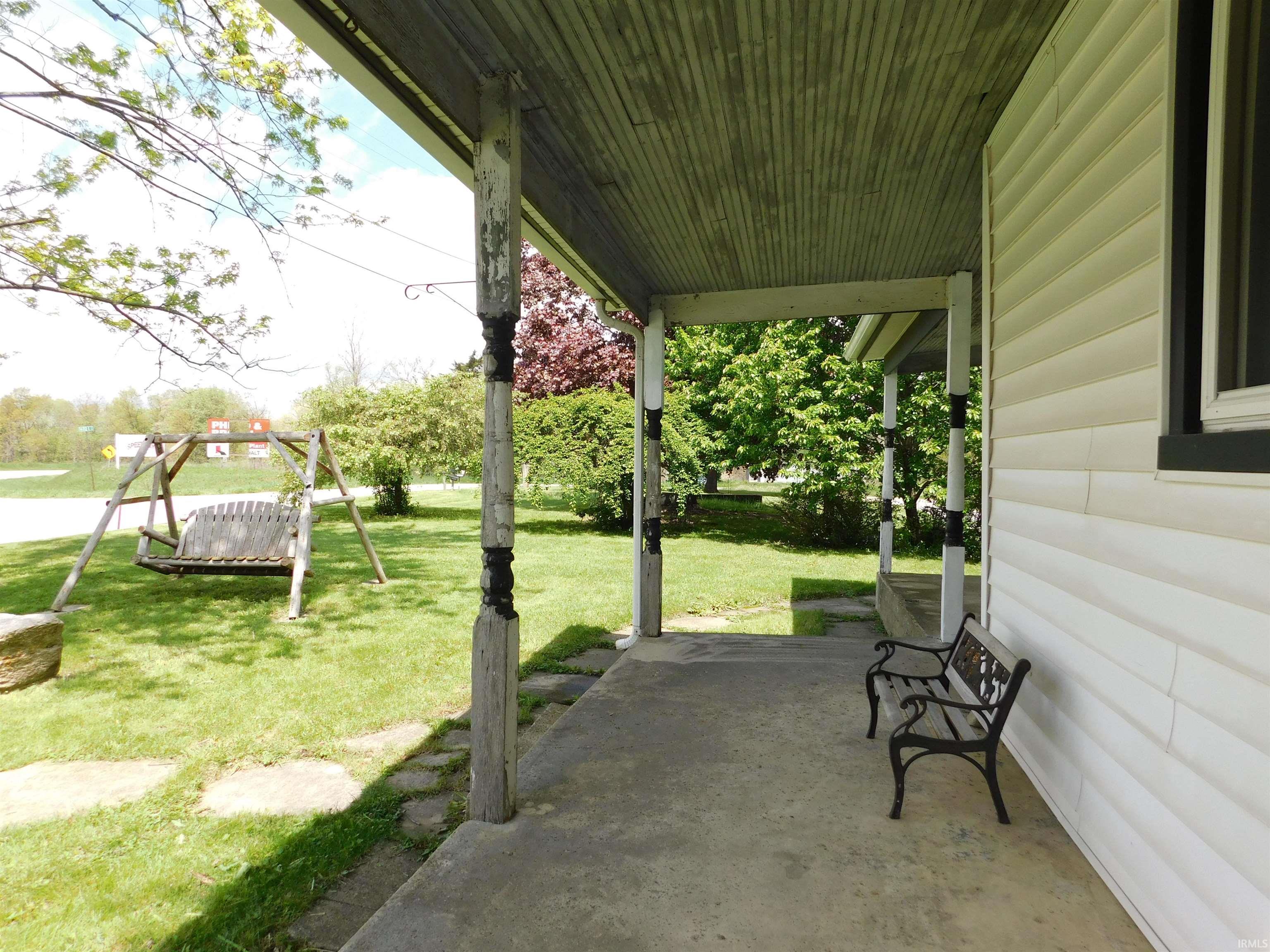 Covered front porch with concrete flooring