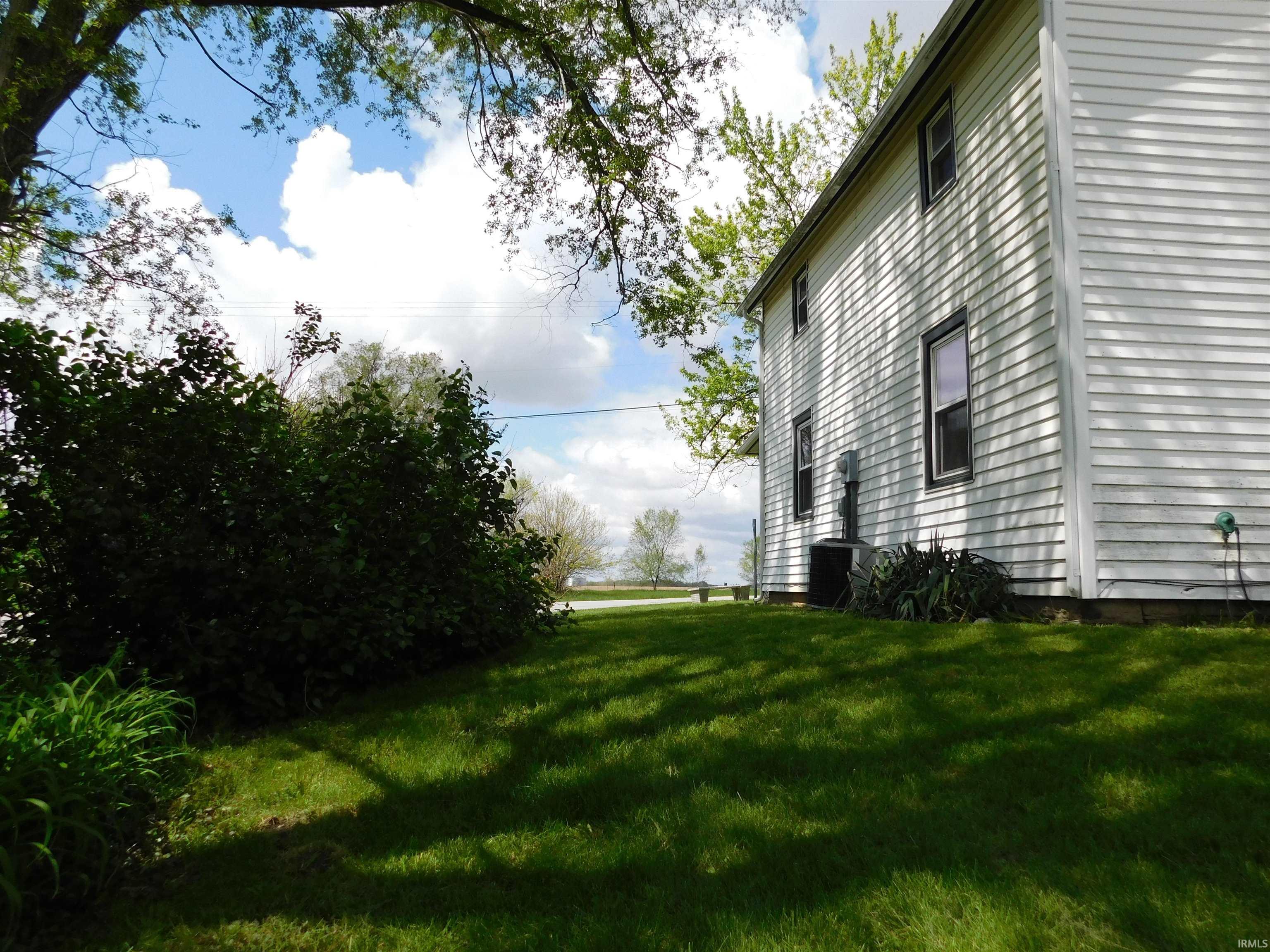 White siding exterior with dark trim windows