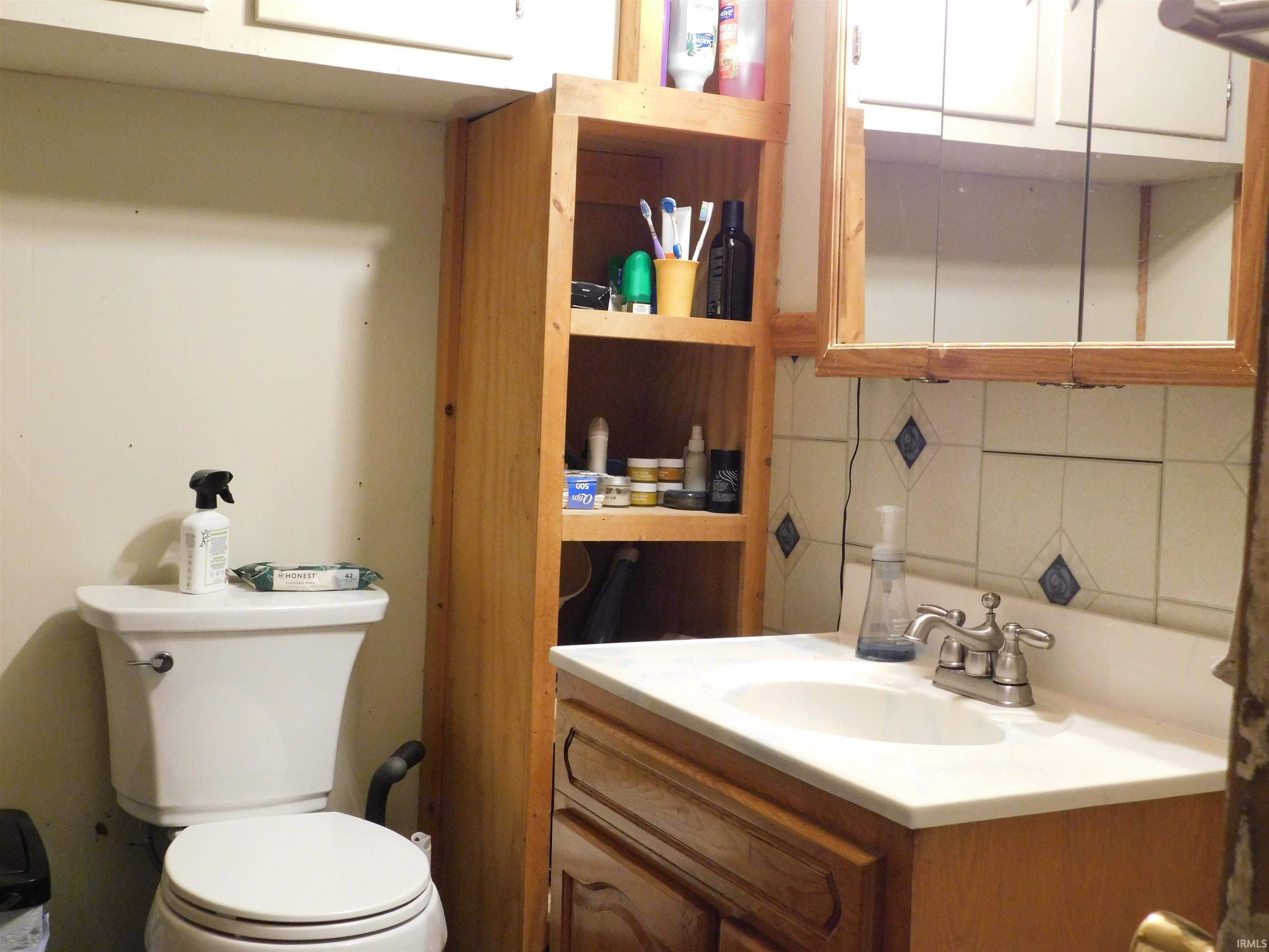 Bathroom vanity featuring an integrated sink with a brushed nickel faucet