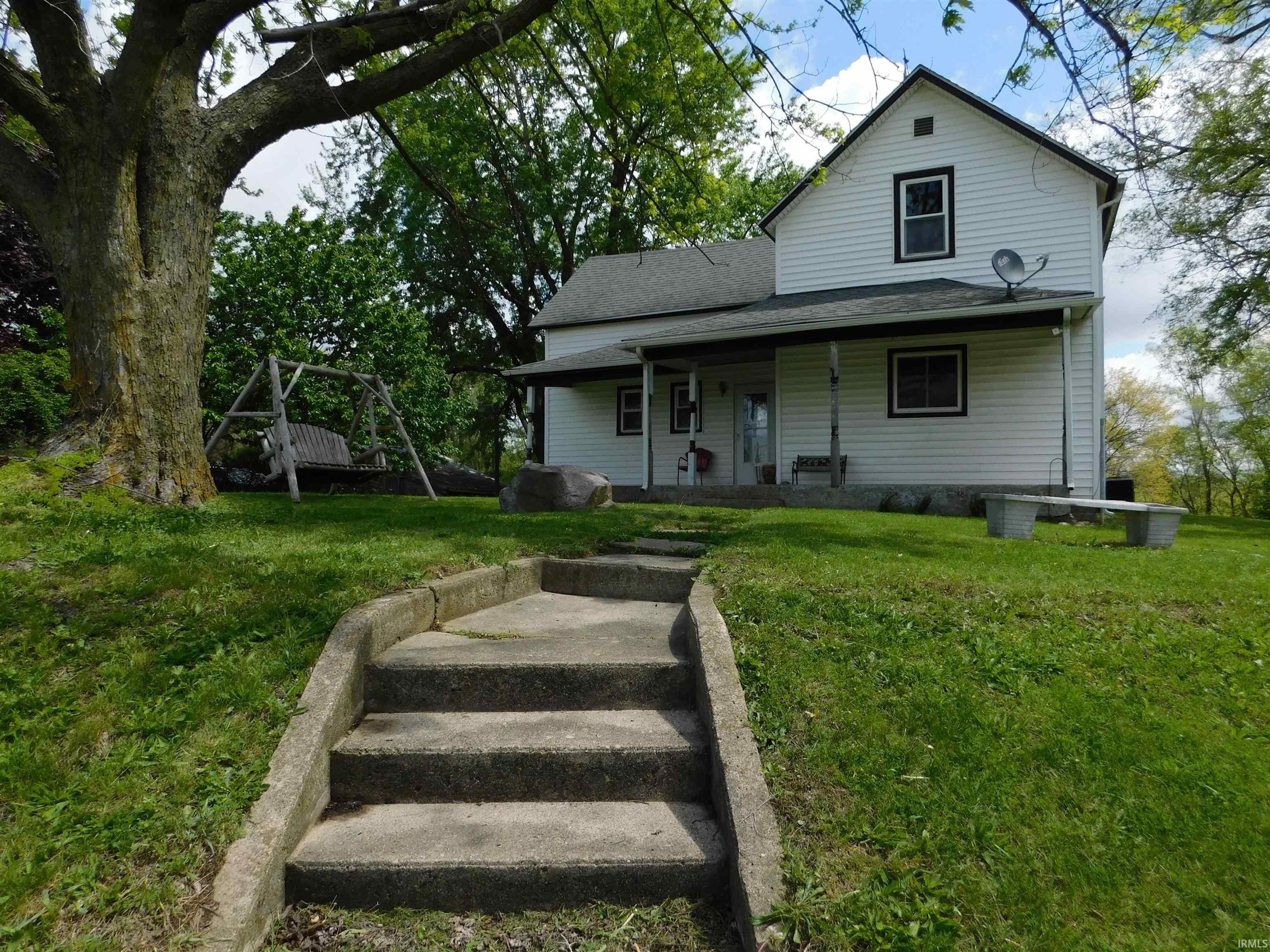 White siding exterior featuring a covered porch
