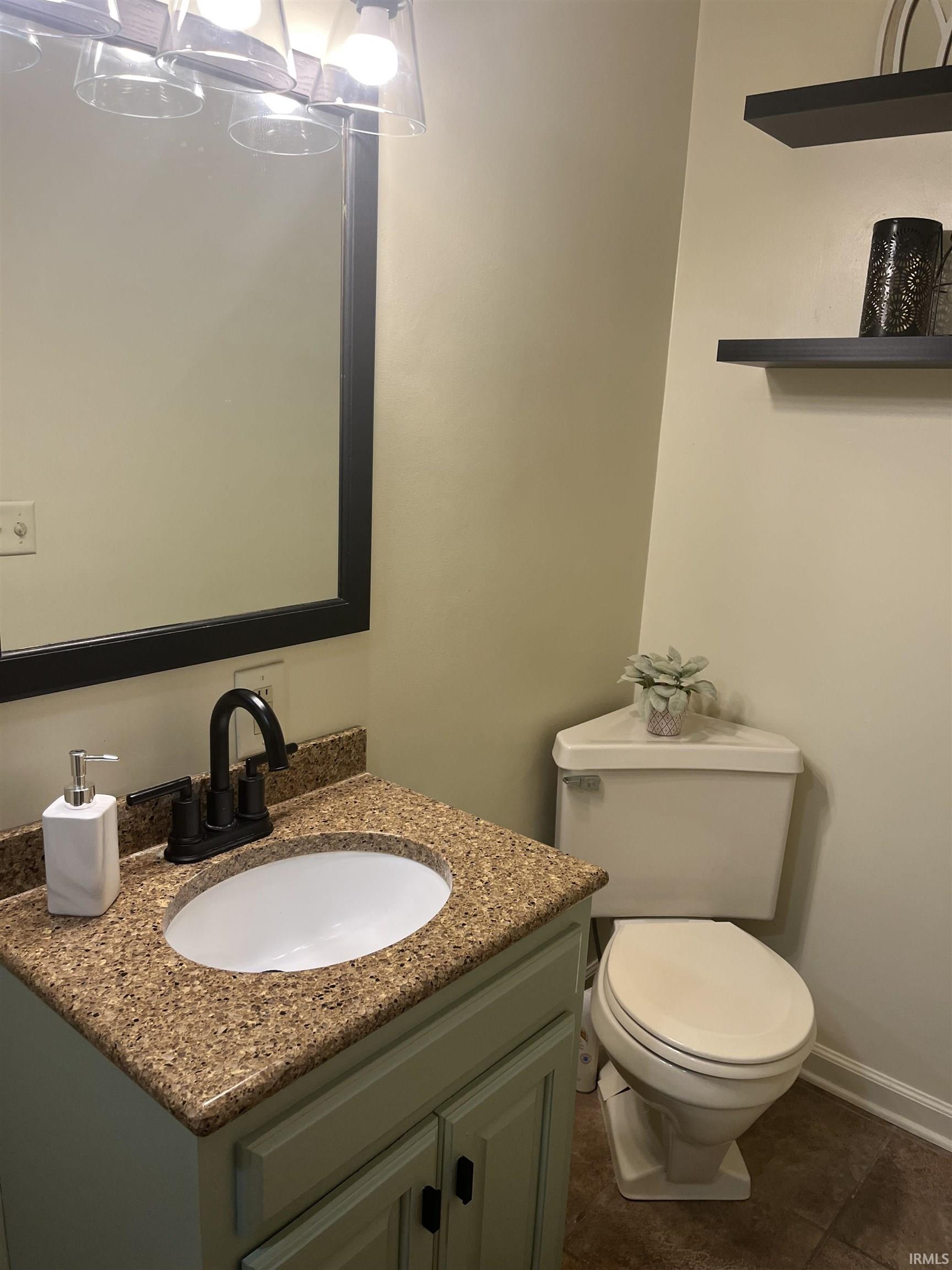 Bathroom featuring a light-colored vanity with a speckled countertop, an oval undermount sink, and a black gooseneck faucet