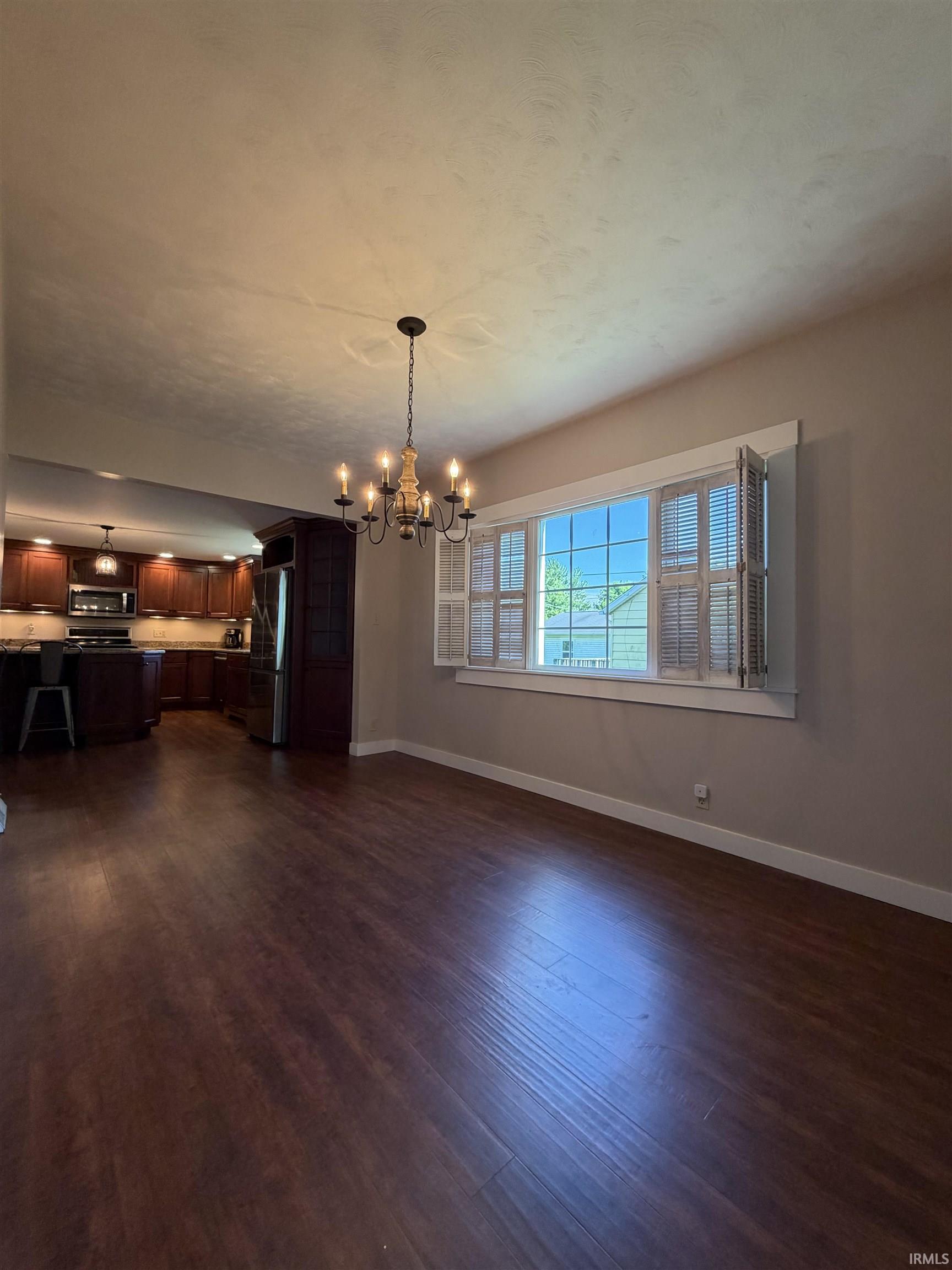 Expansive wood-finish flooring throughout the dining area