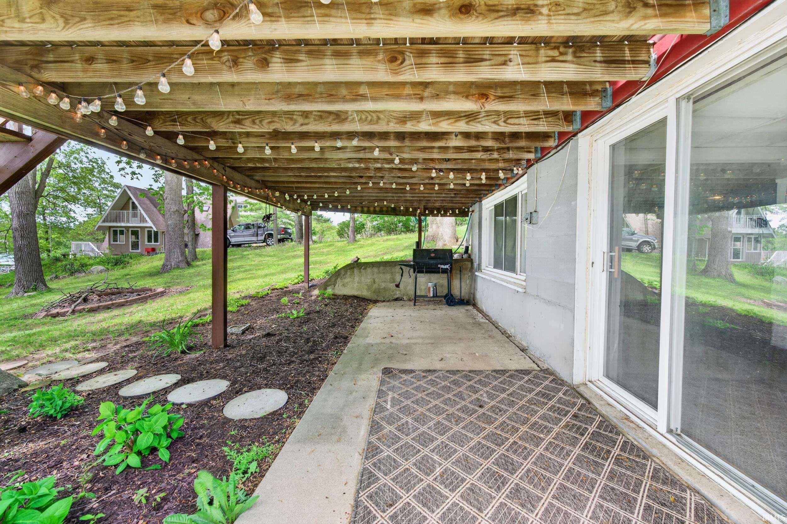 Covered patio space featuring a concrete slab and sliding glass door access