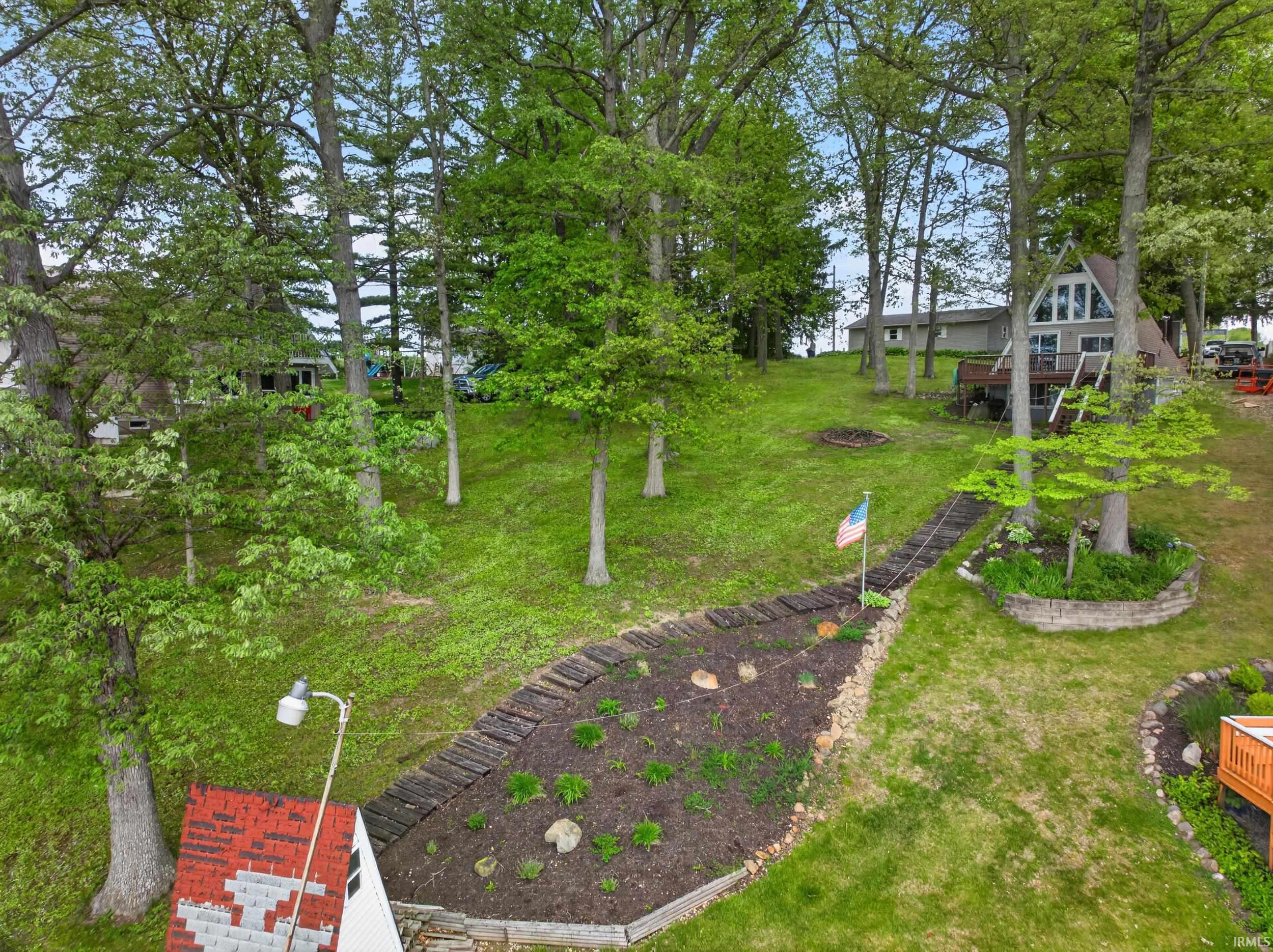 Wooded hillside property featuring a distinctive A-frame residence with an elevated deck