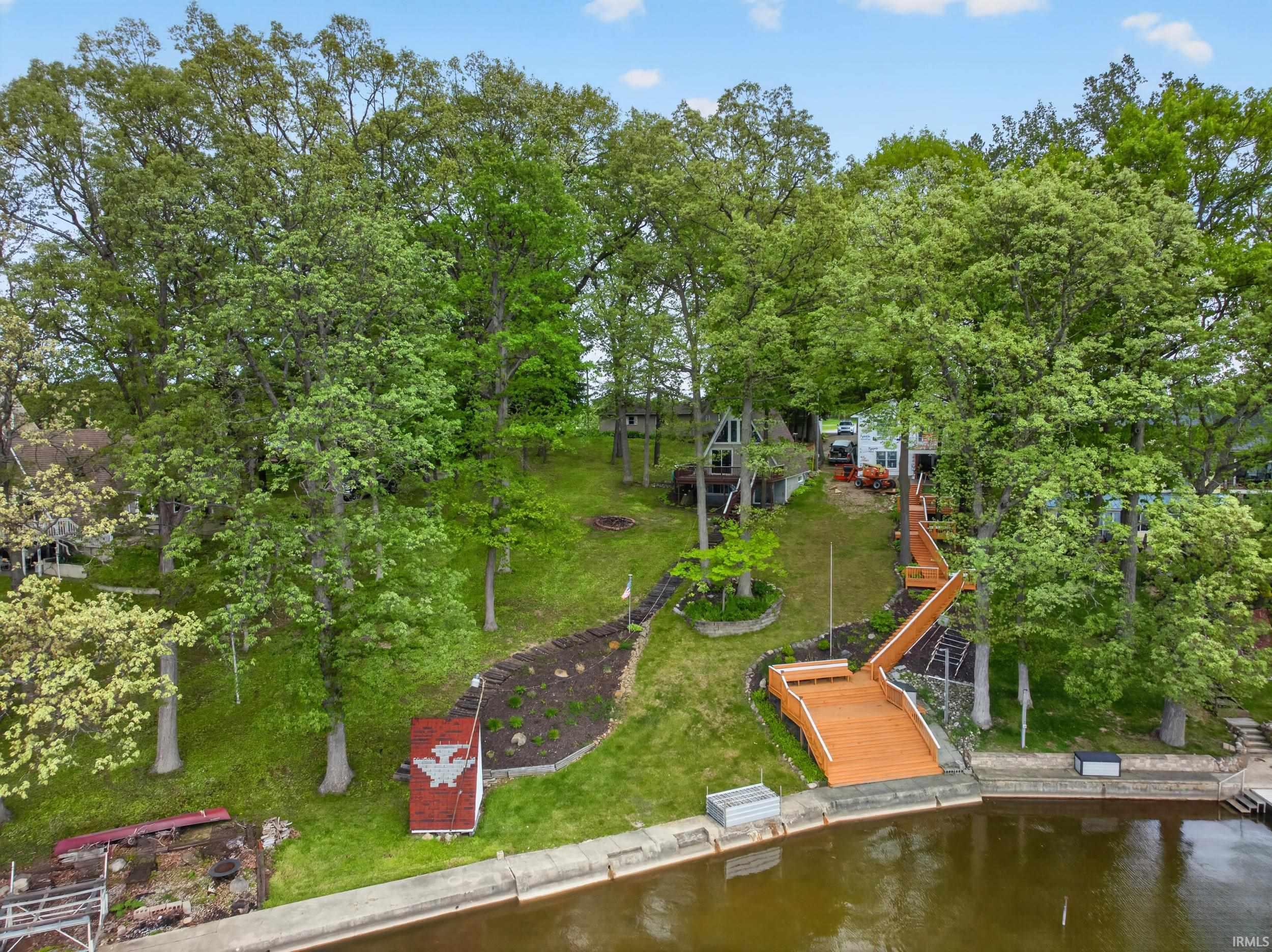 Waterfront property featuring a sloped, treed lot with direct water access