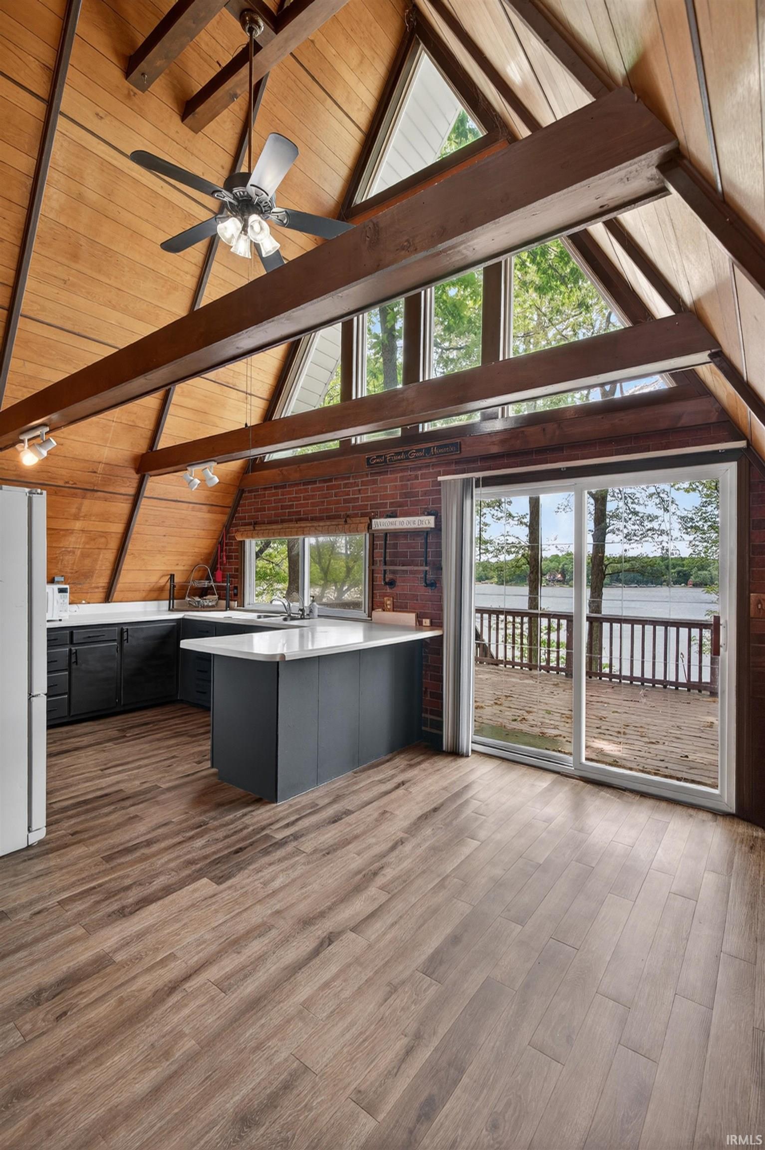A-frame architecture featuring wood-finish vaulted ceilings with exposed beams
