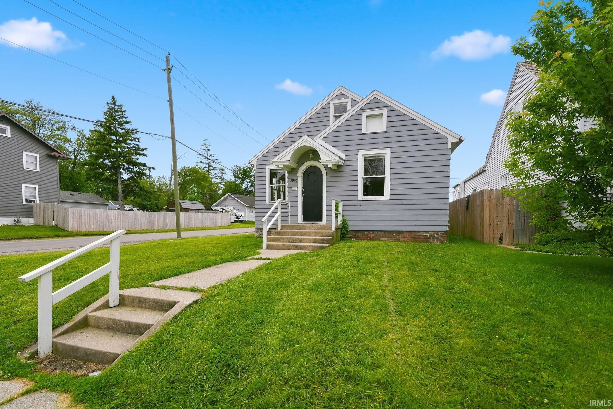 Light gray siding home with white trim and a gabled roof