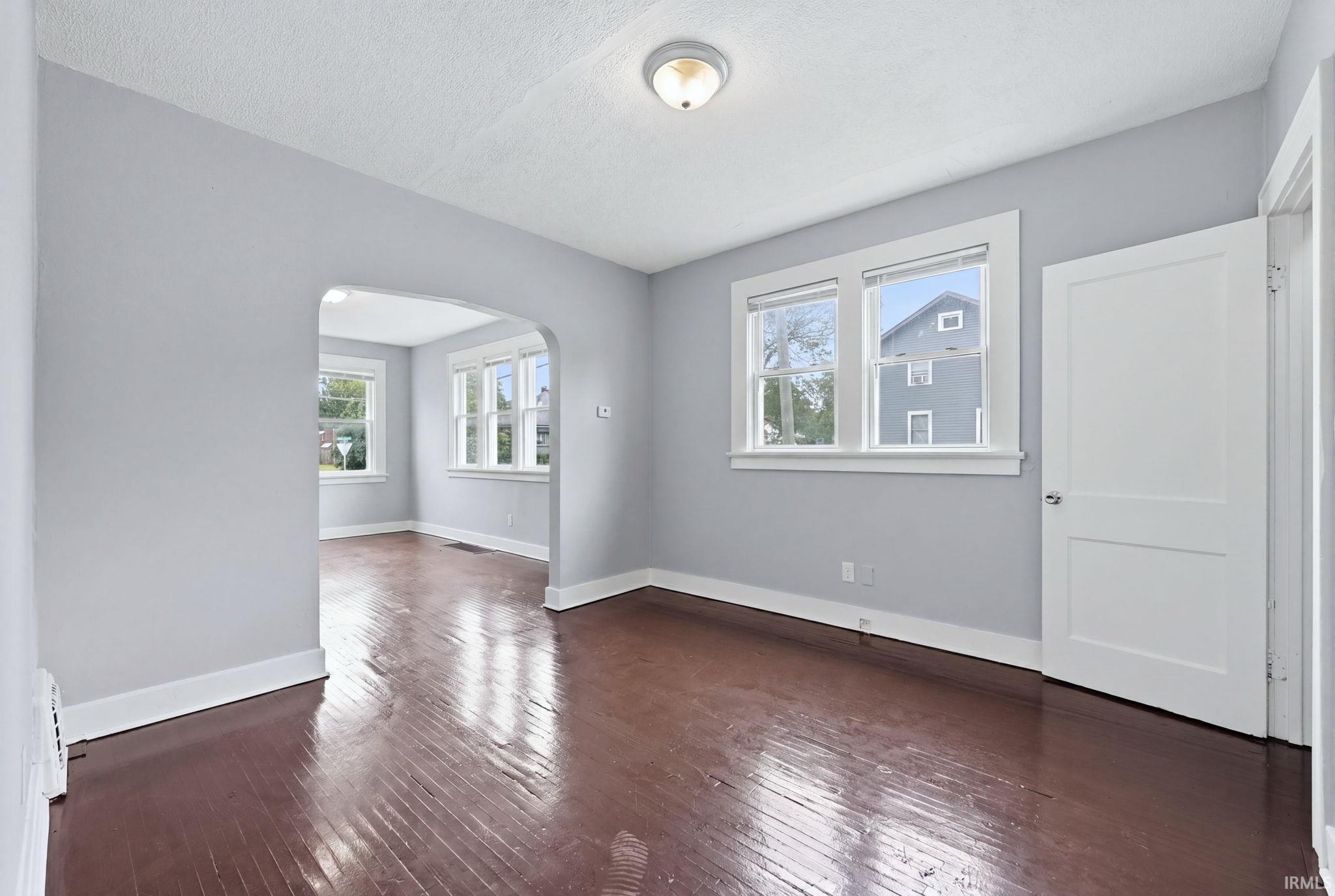 Hardwood-finish flooring throughout, complemented by light gray walls and white trim