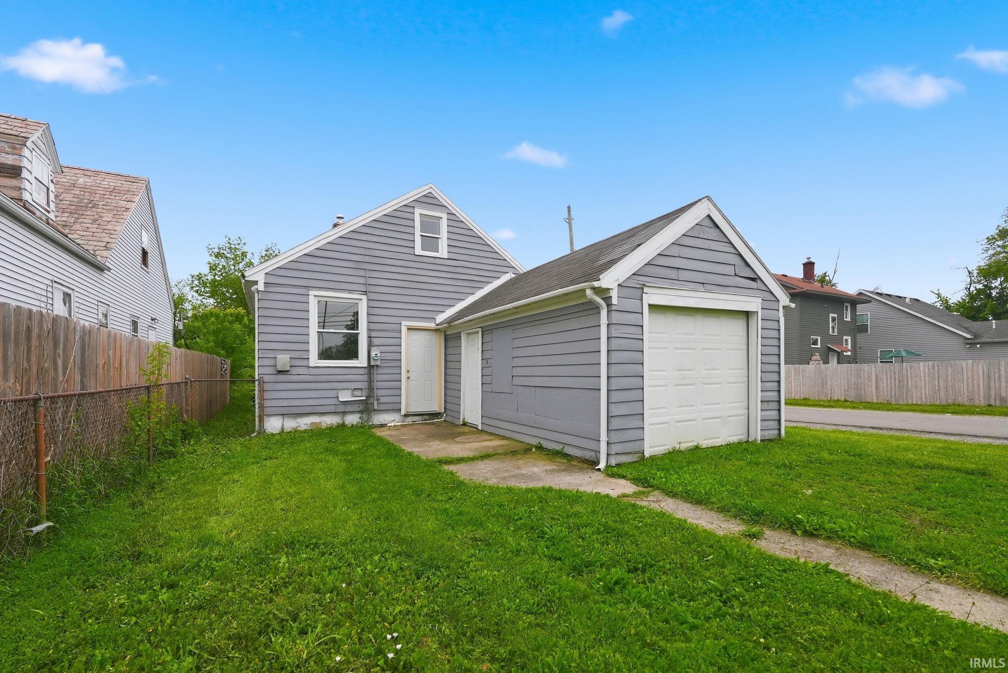 Rear exterior of a single-story residence with gray siding and white trim