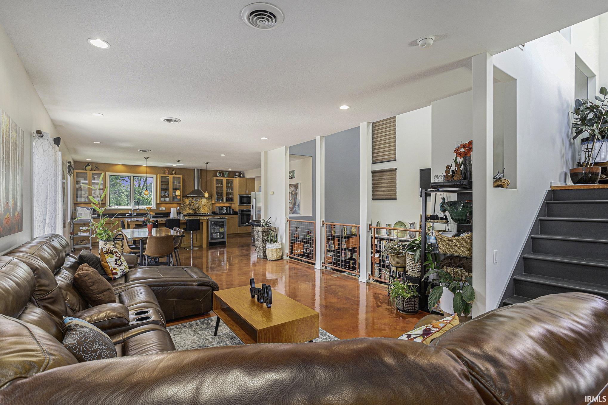 Open-concept living area with polished concrete flooring