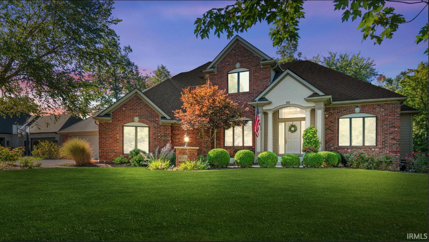Brick exterior with gabled architectural details and an arched portico entry