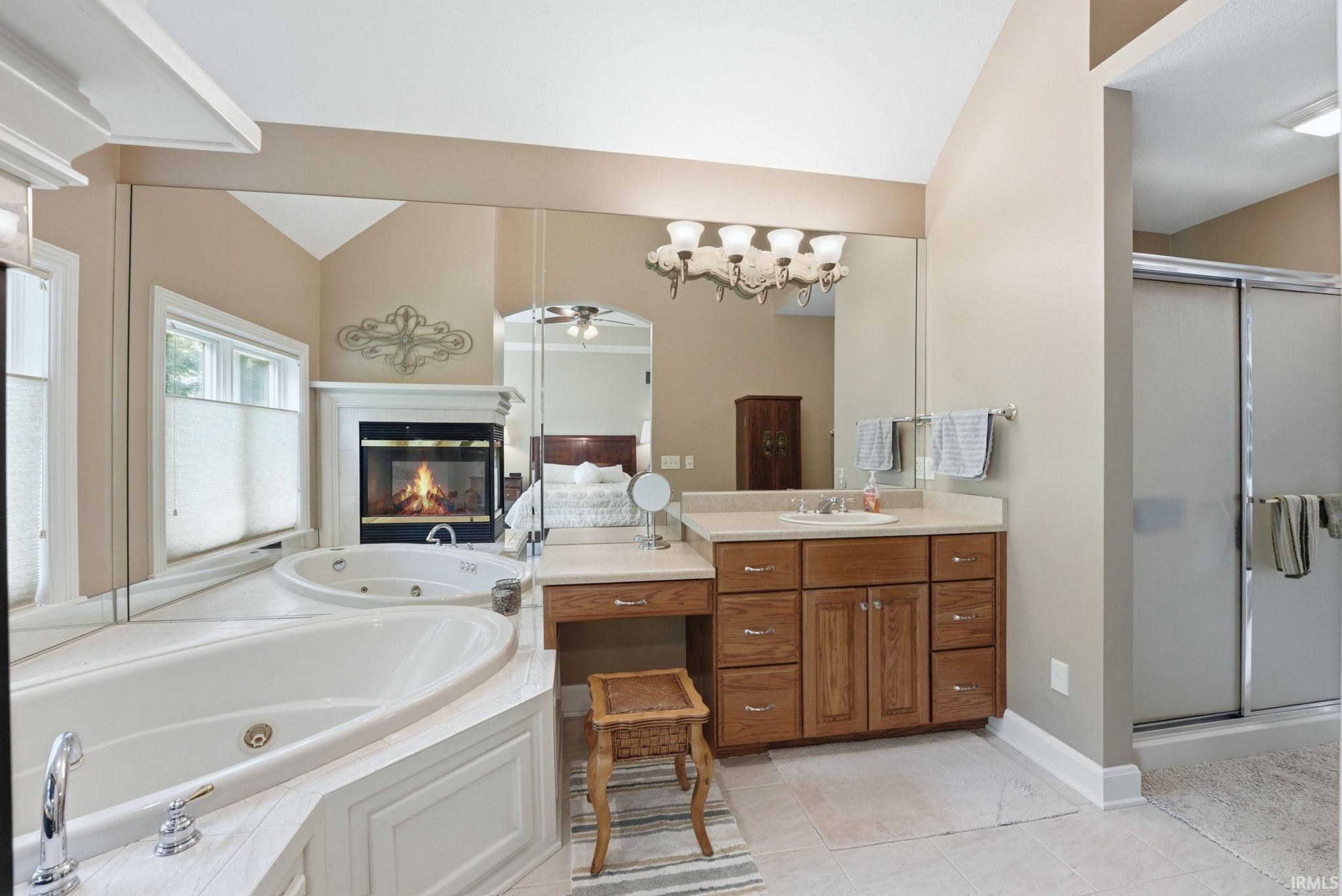 Built-in jetted tub with surrounding white paneling