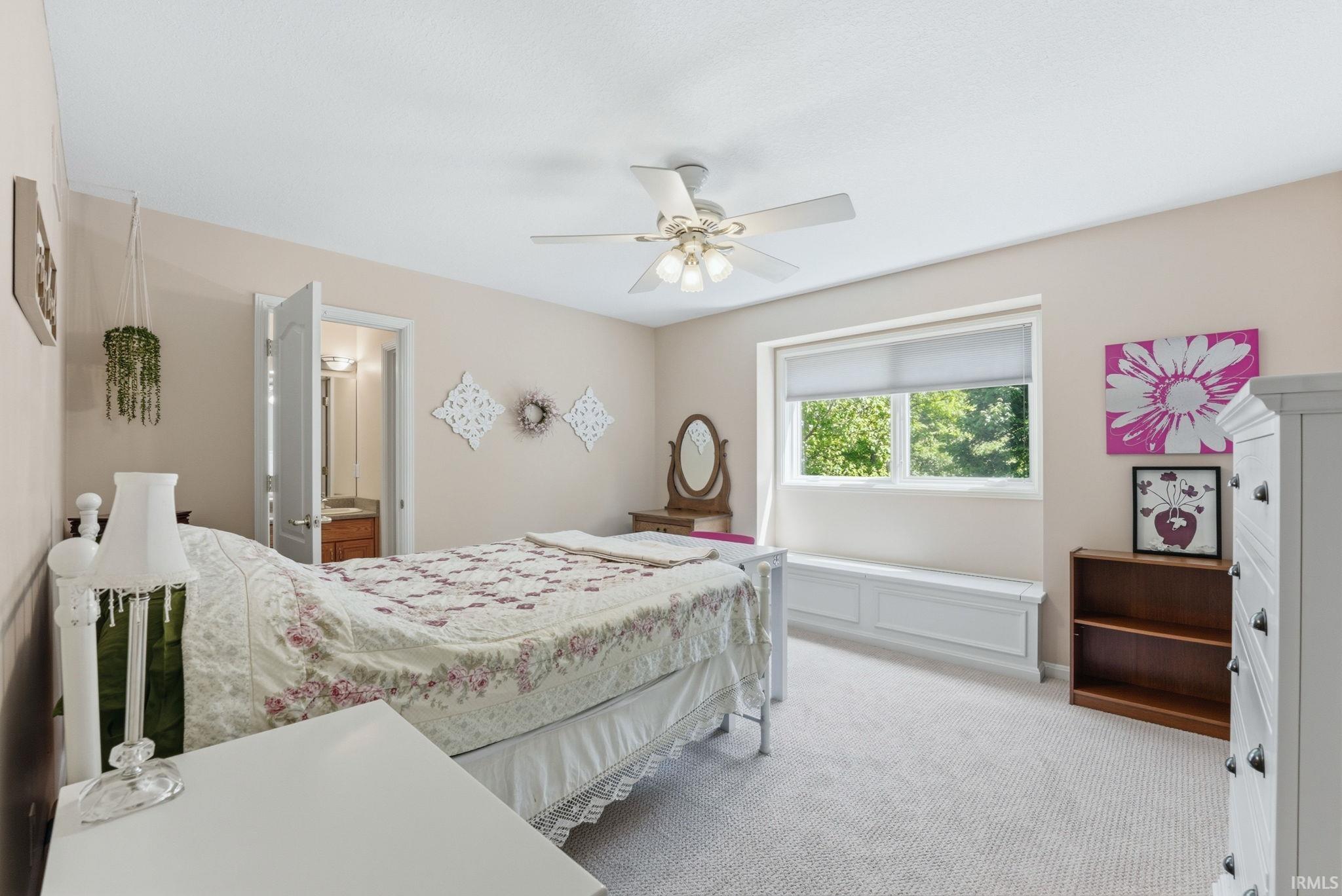 Spacious room featuring neutral carpeting and wall tones