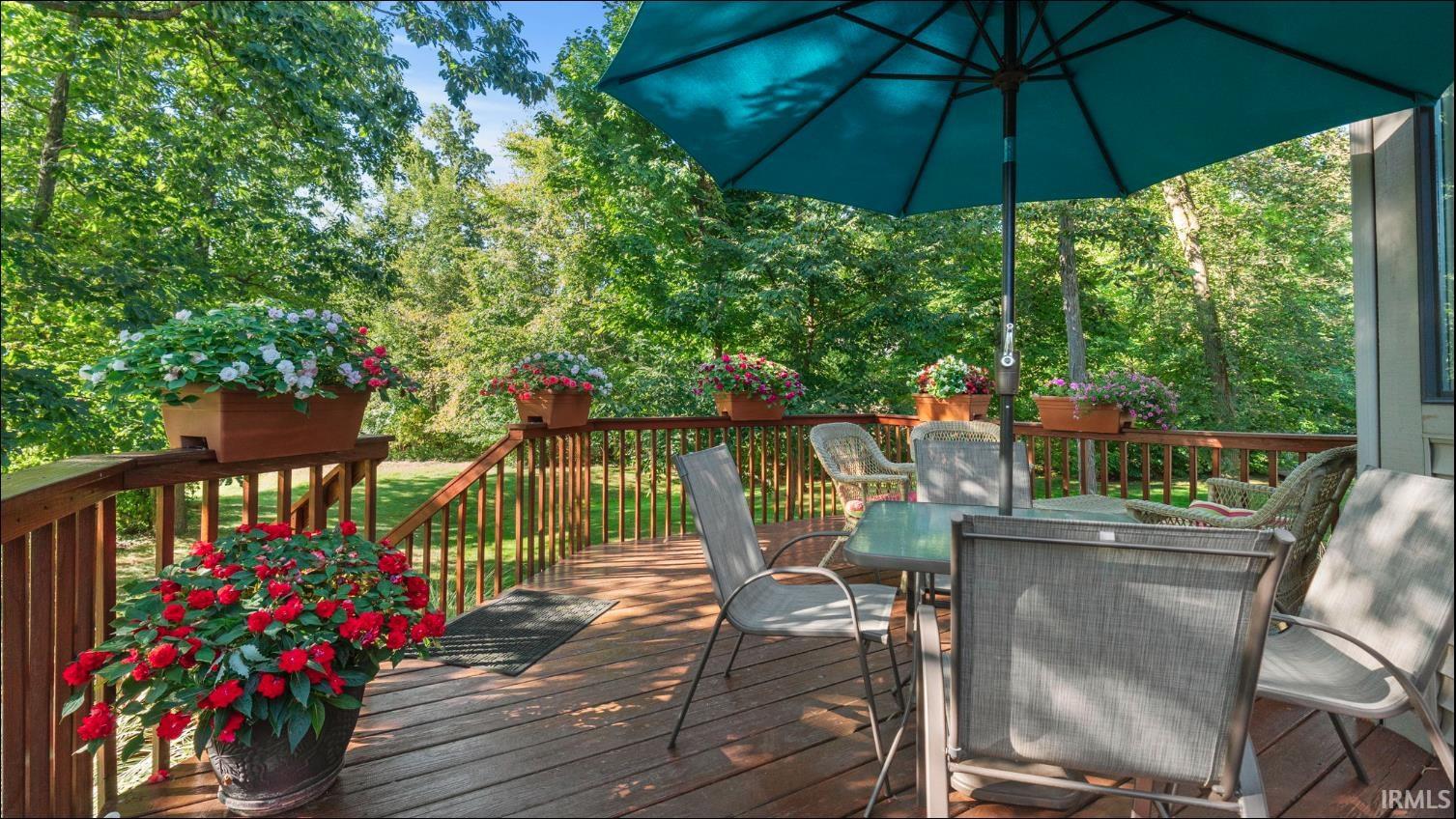 Spacious outdoor deck featuring natural wood flooring and railing