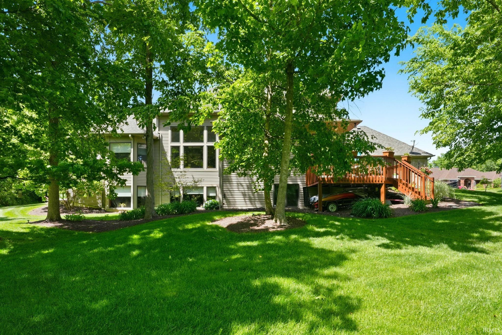 Expansive rear exterior featuring a two-story design with a multi-pane window wall