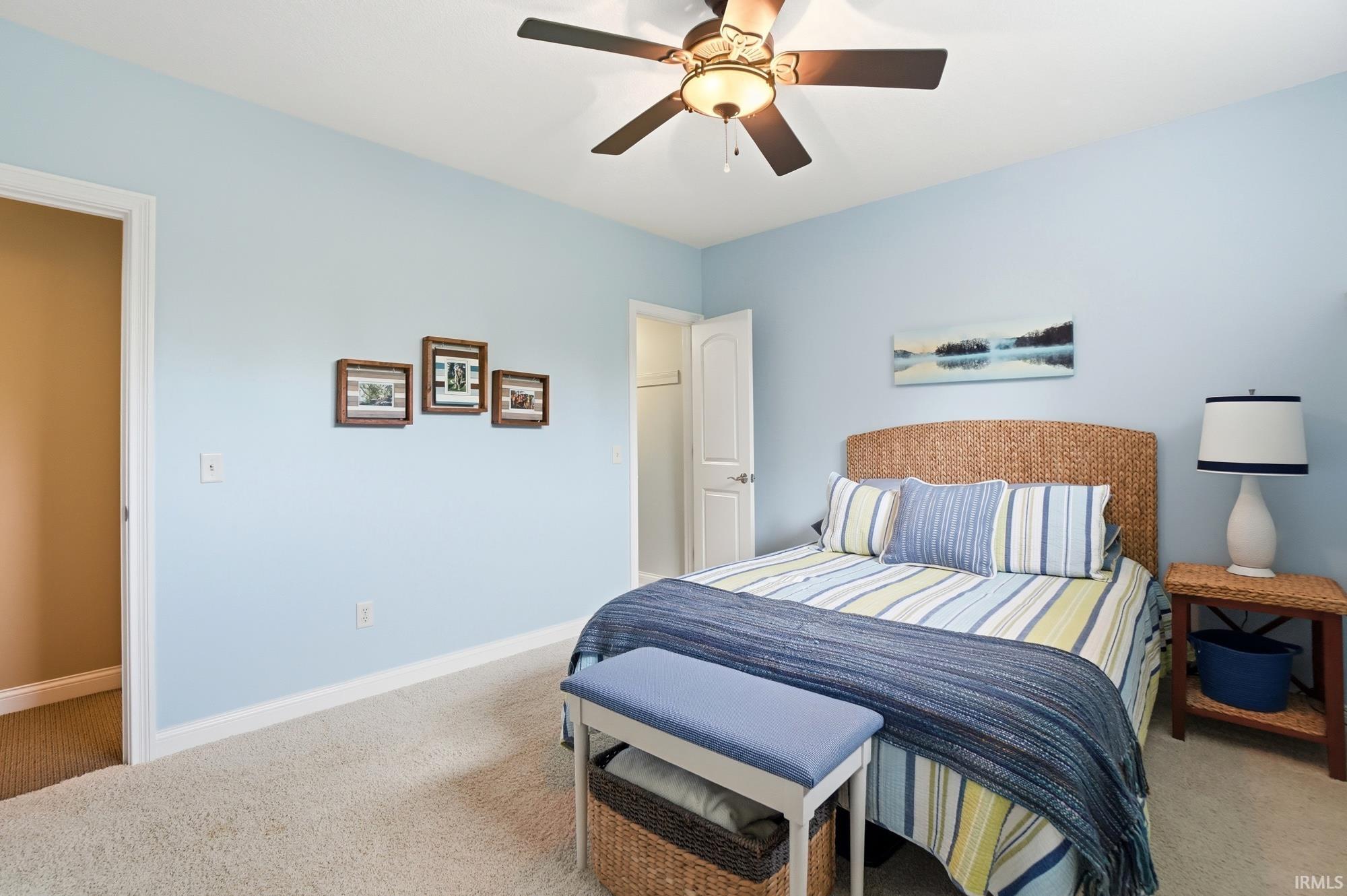 Carpeted room with light blue walls and white baseboards