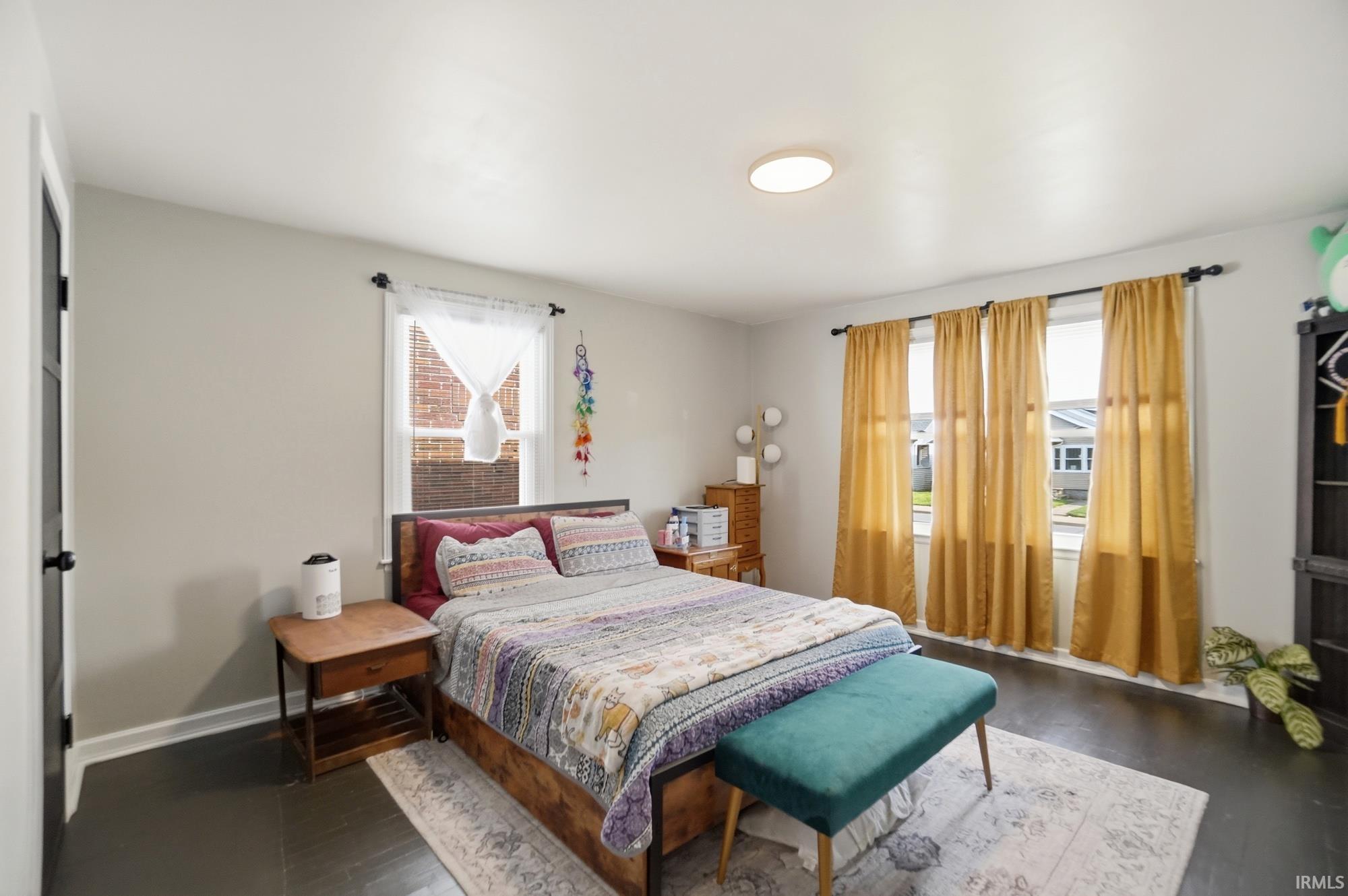 Light gray walls complement the dark wood-finish flooring in this room