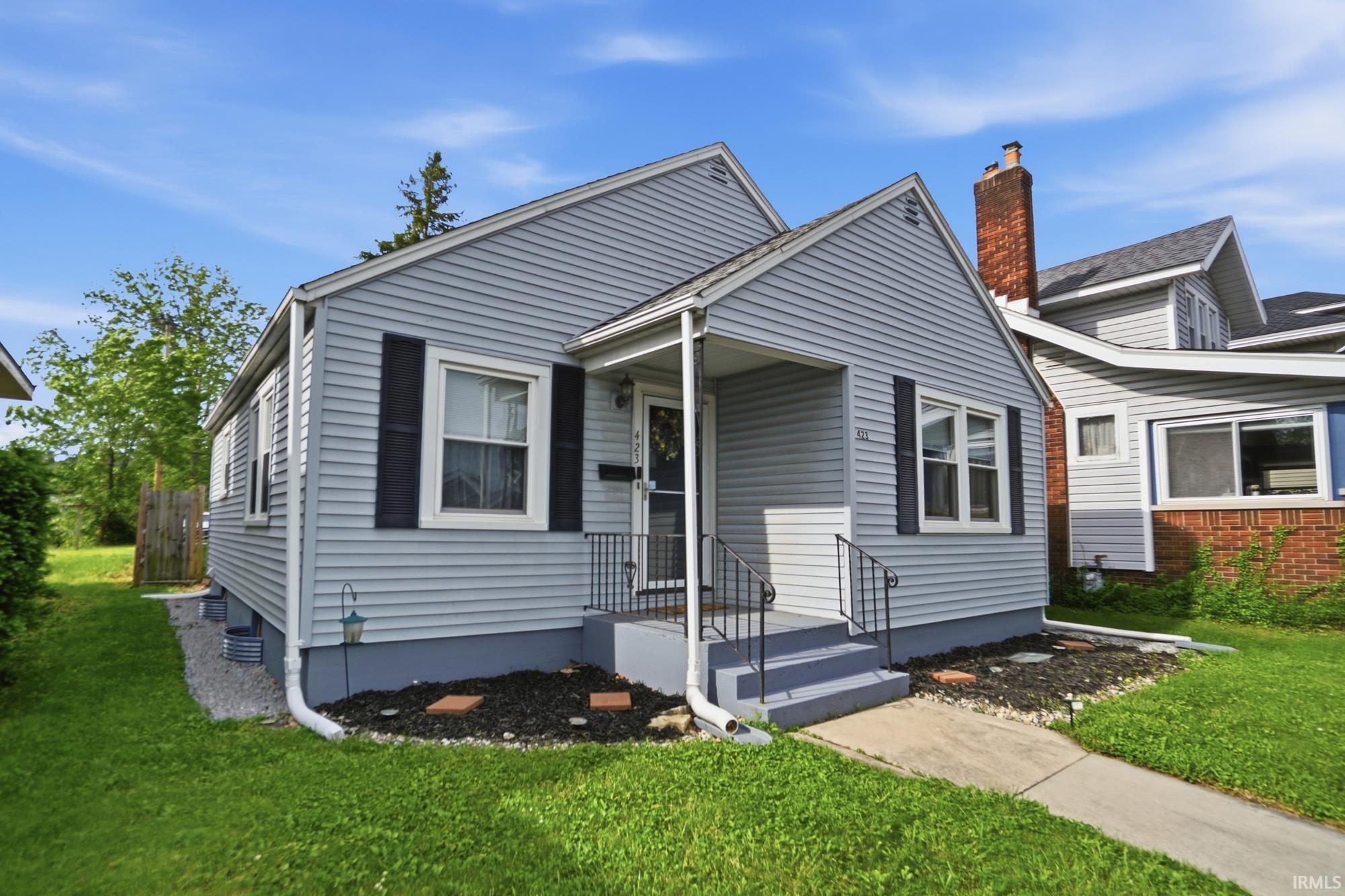 Light blue siding exterior with dark shutters