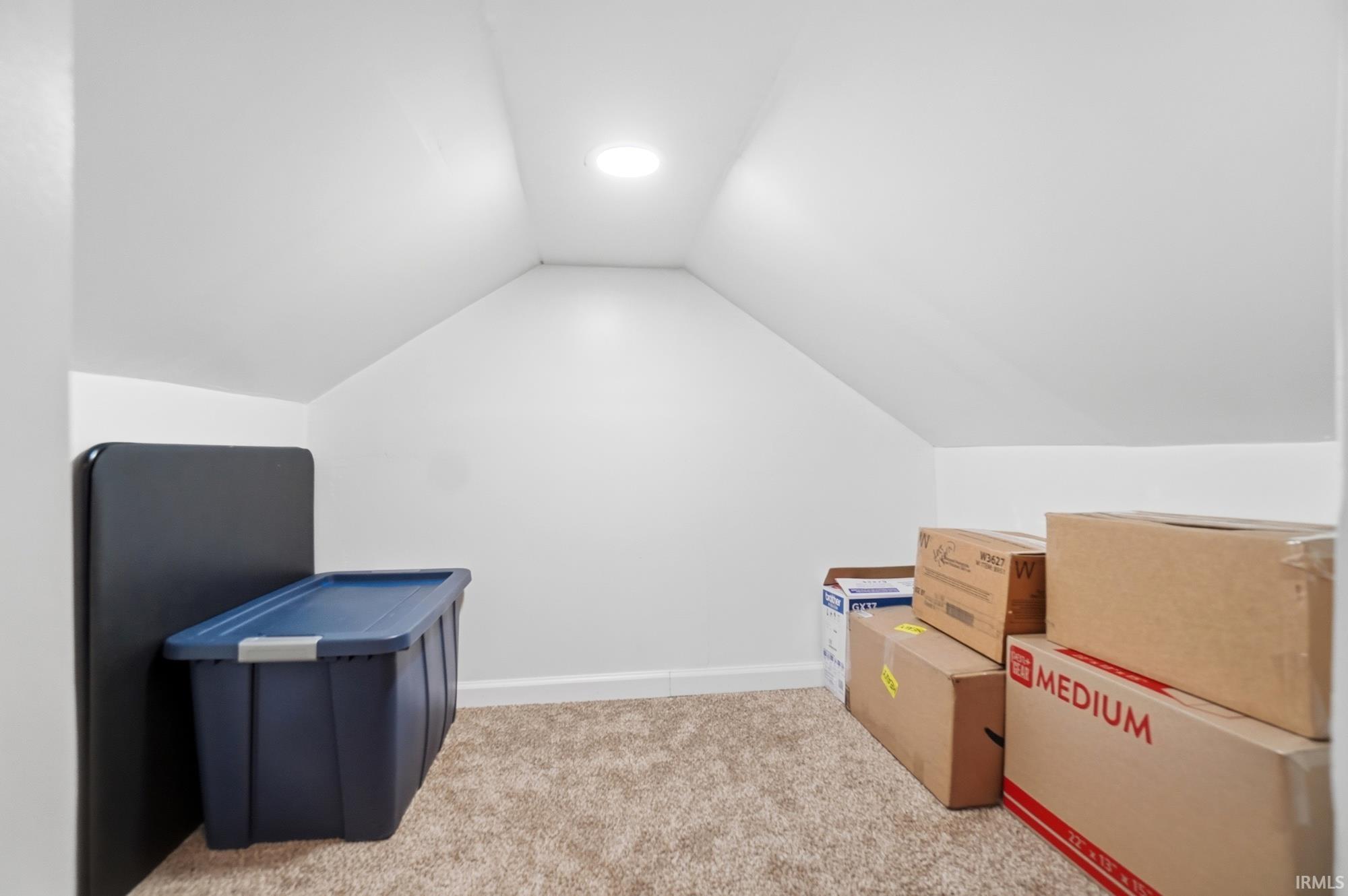 Carpeted bonus space featuring sloped ceilings, recessed lighting, and white baseboards