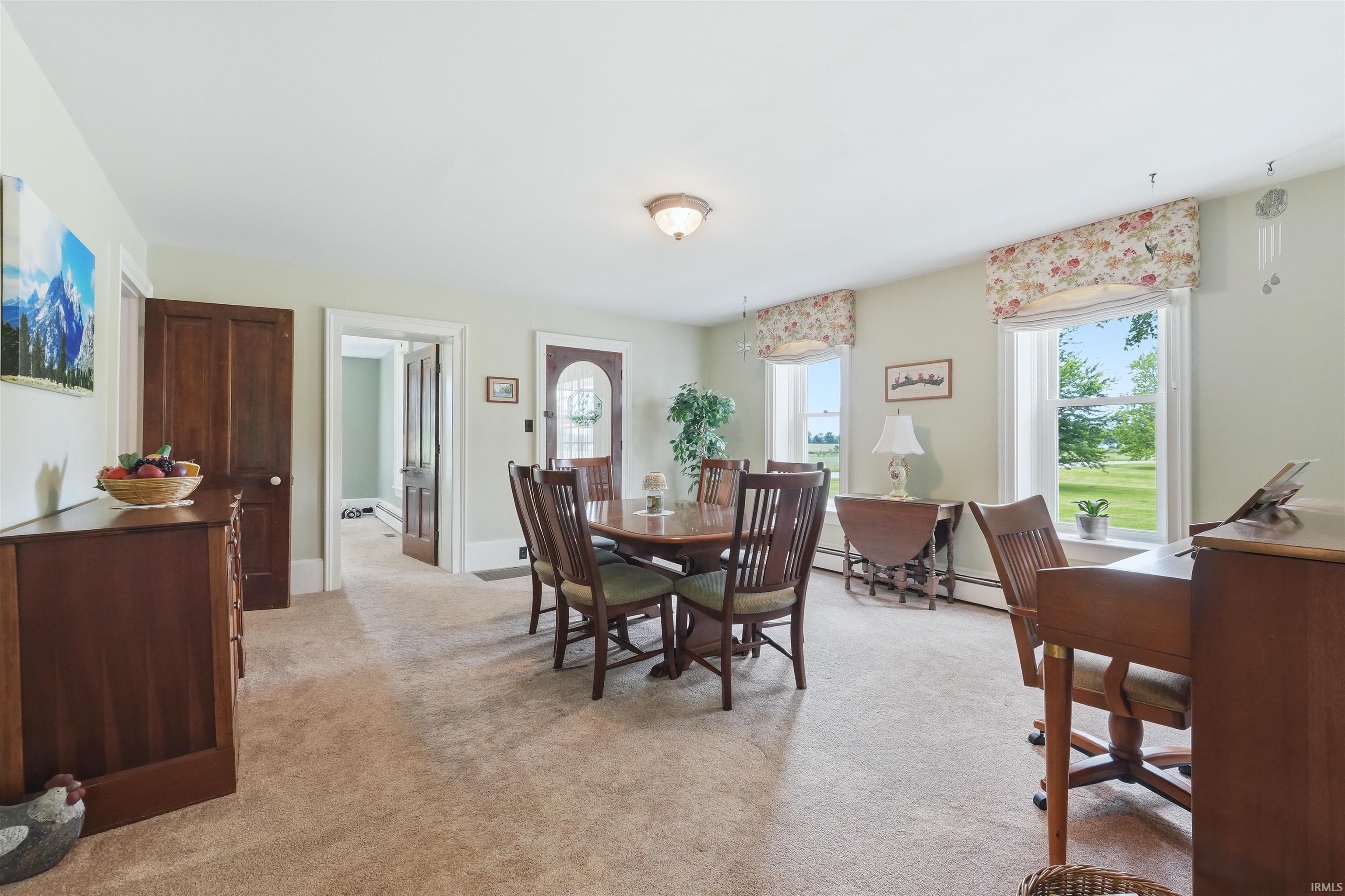 Expansive room with neutral carpeting and light-toned wall paint