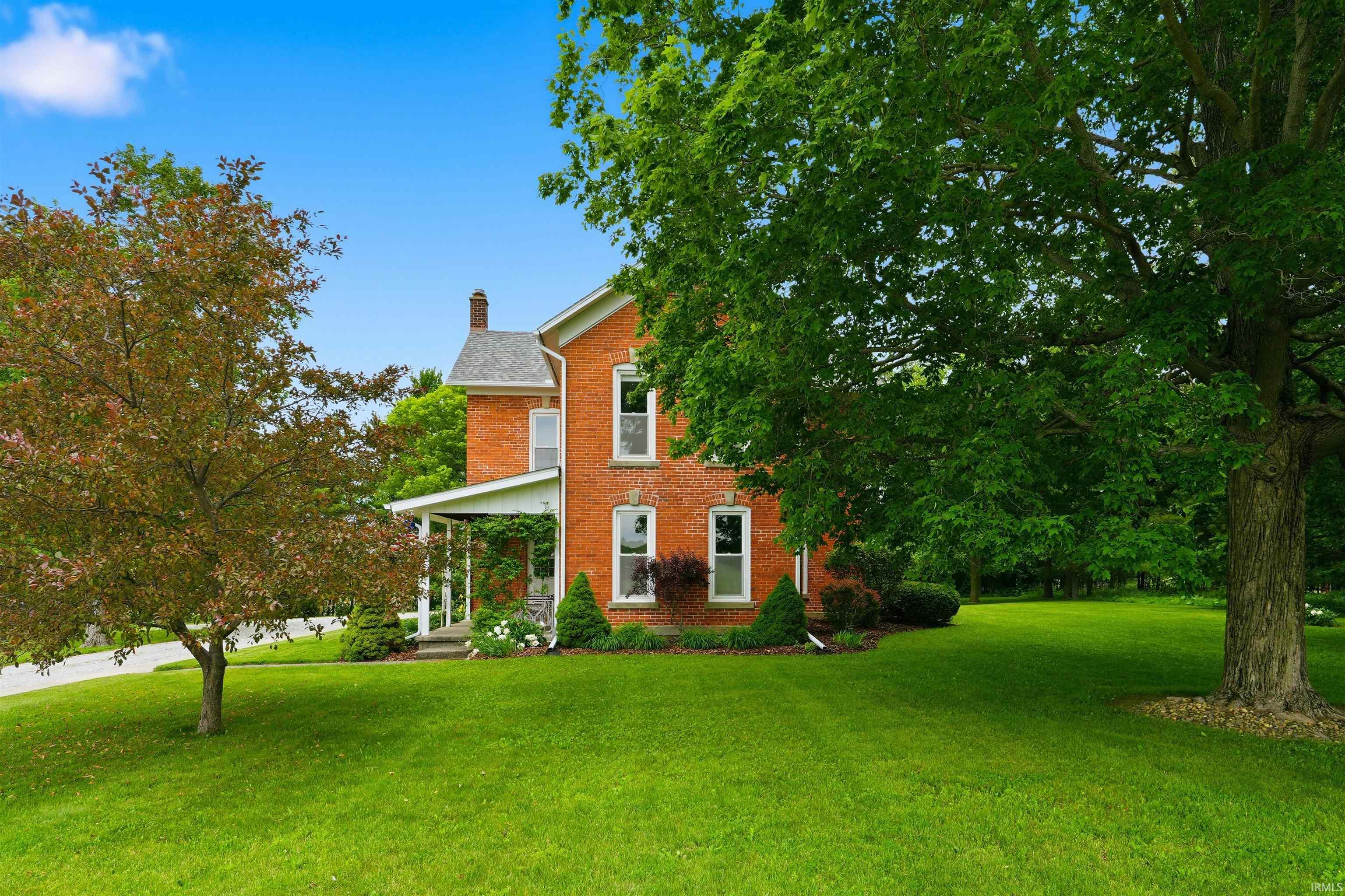 Two-story brick exterior with white trim and a covered front porch