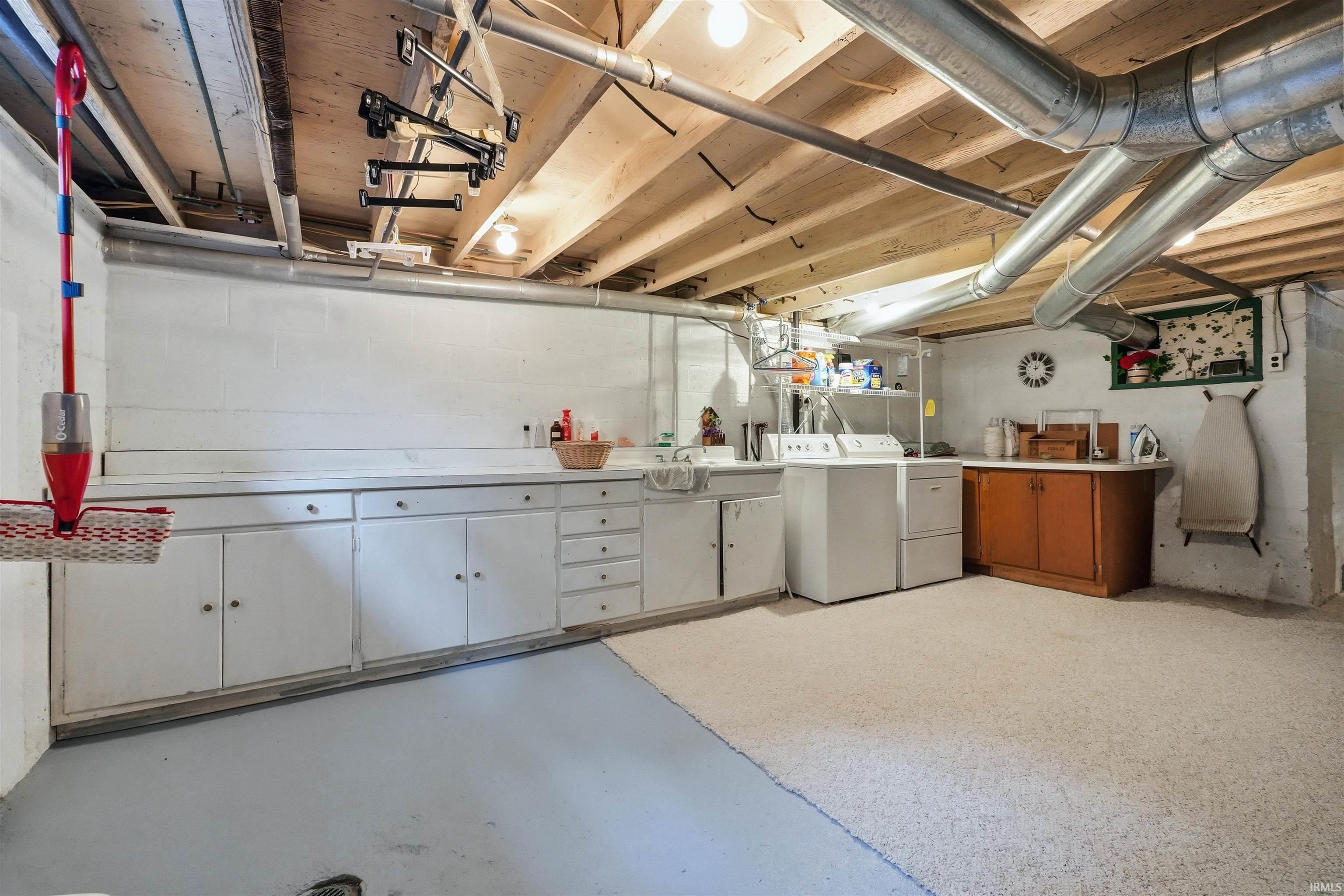 Utility space featuring exposed ceiling joists and ductwork