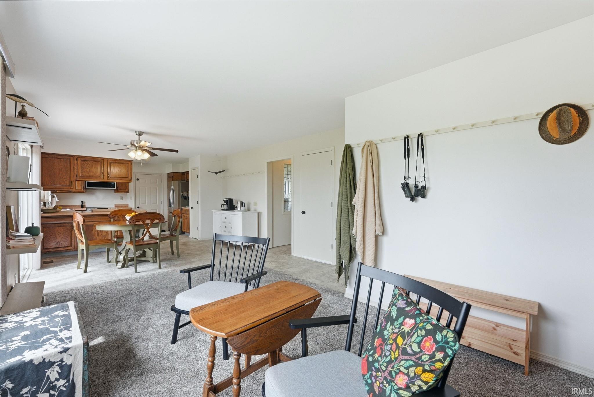 Open-concept living space with light gray carpet and white walls