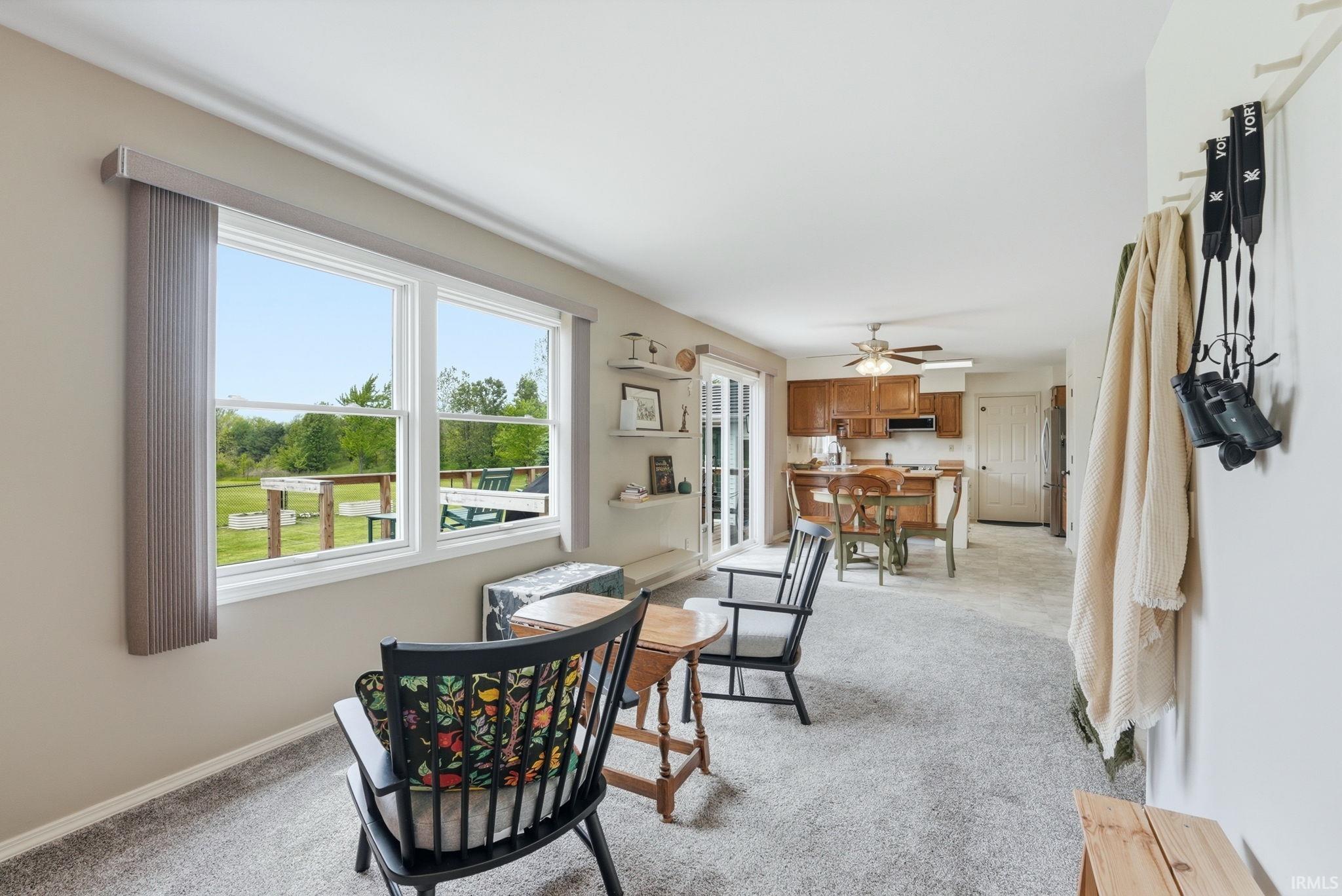 Bright living area featuring large windows with outdoor views