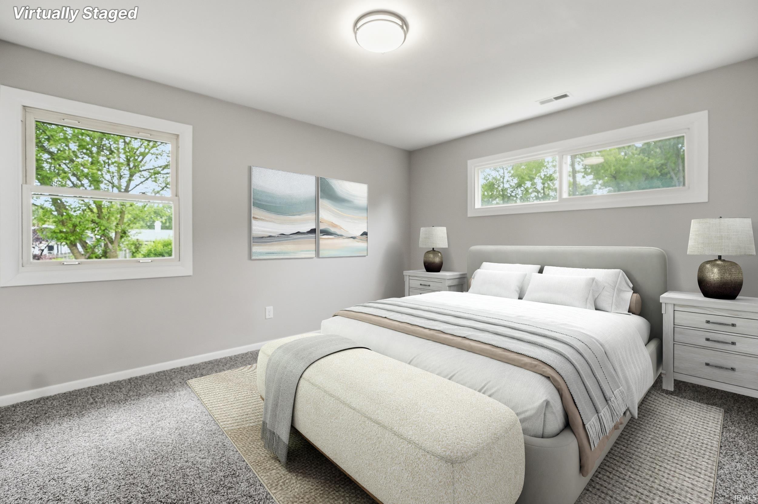 Light-filled interior featuring soft gray wall tones and gray textured carpeting