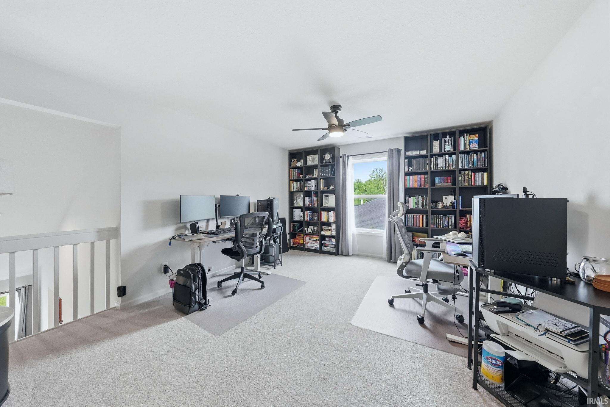 Spacious room with light-colored carpeting and white walls