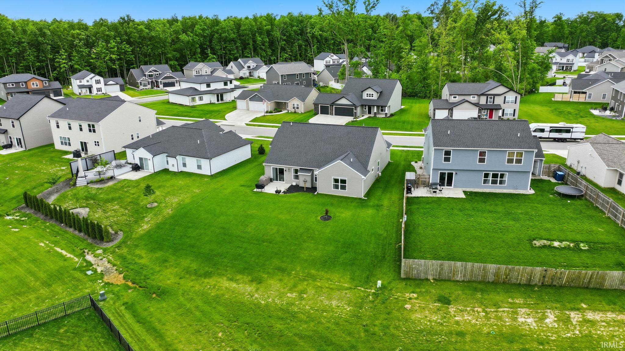 Expansive green lawns surround multiple properties