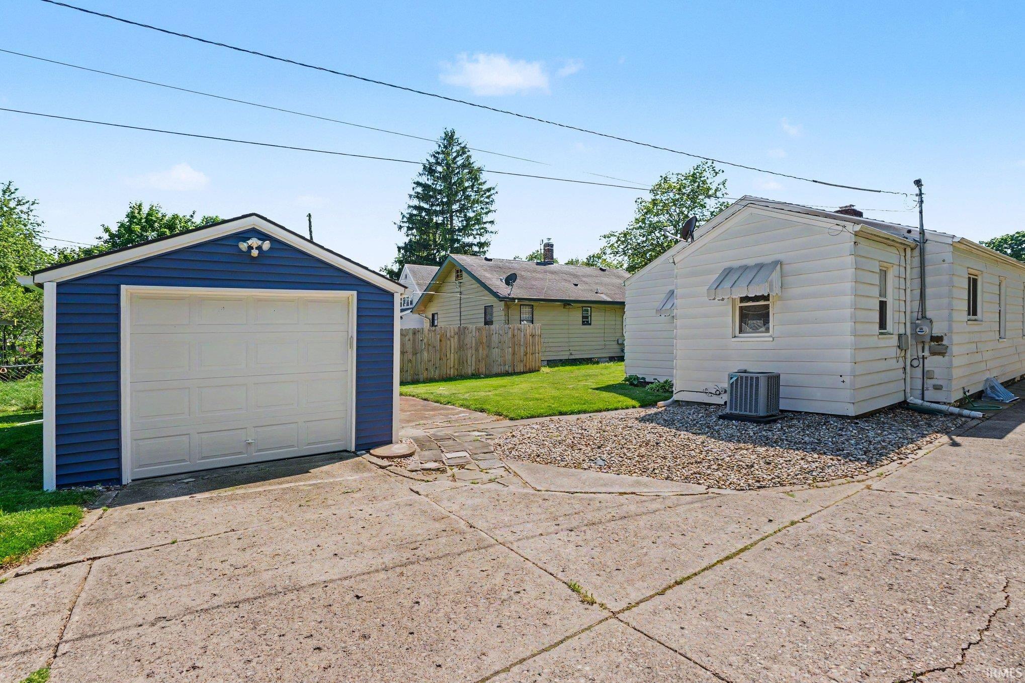 Detached garage with blue siding and white garage door