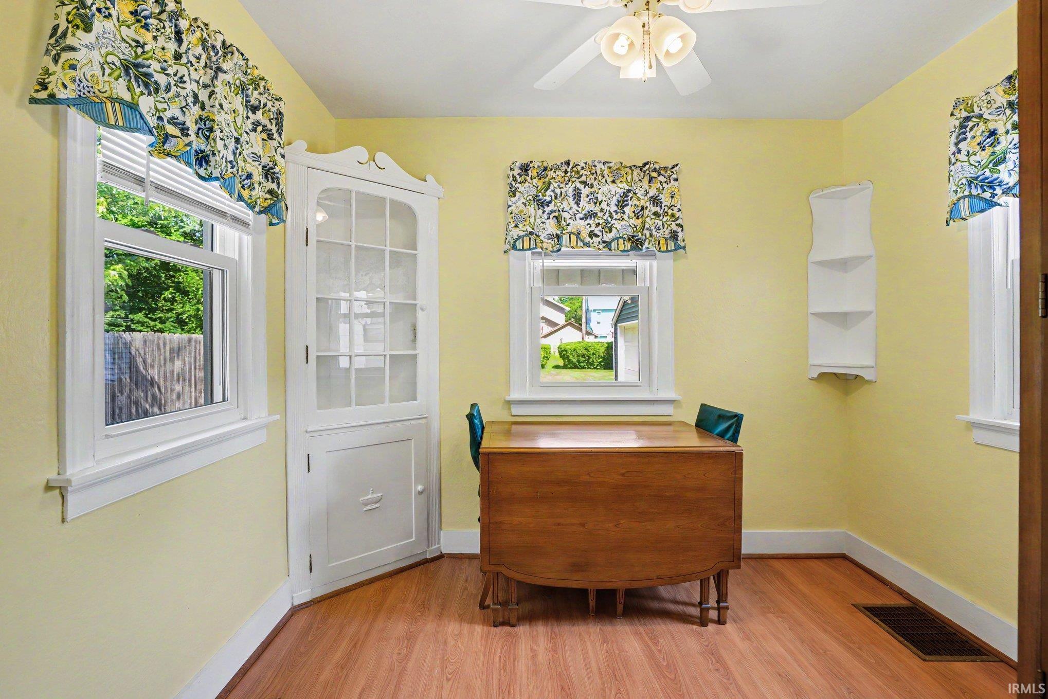 Corner built-in display cabinet with glass-front upper doors