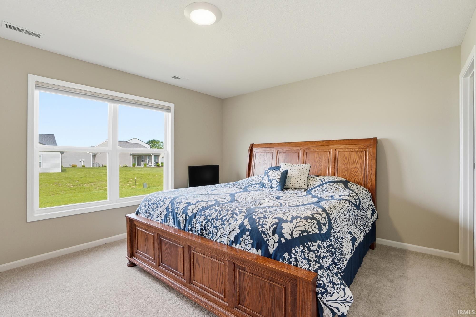 Bright bedroom with a large window offering expansive outdoor scenery