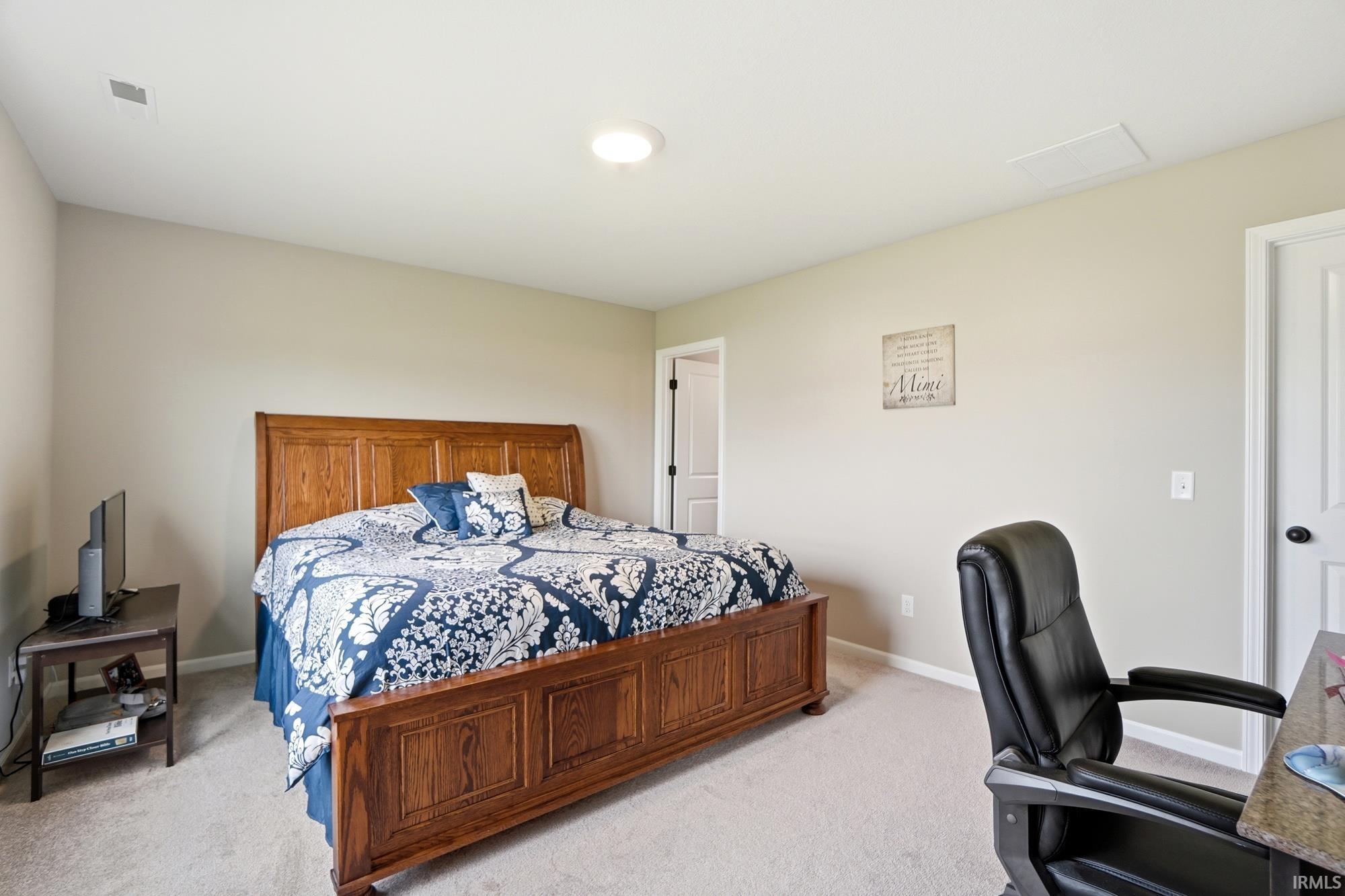 Neutral wall paint with recessed ceiling lighting, light-toned carpet flooring, and white trim